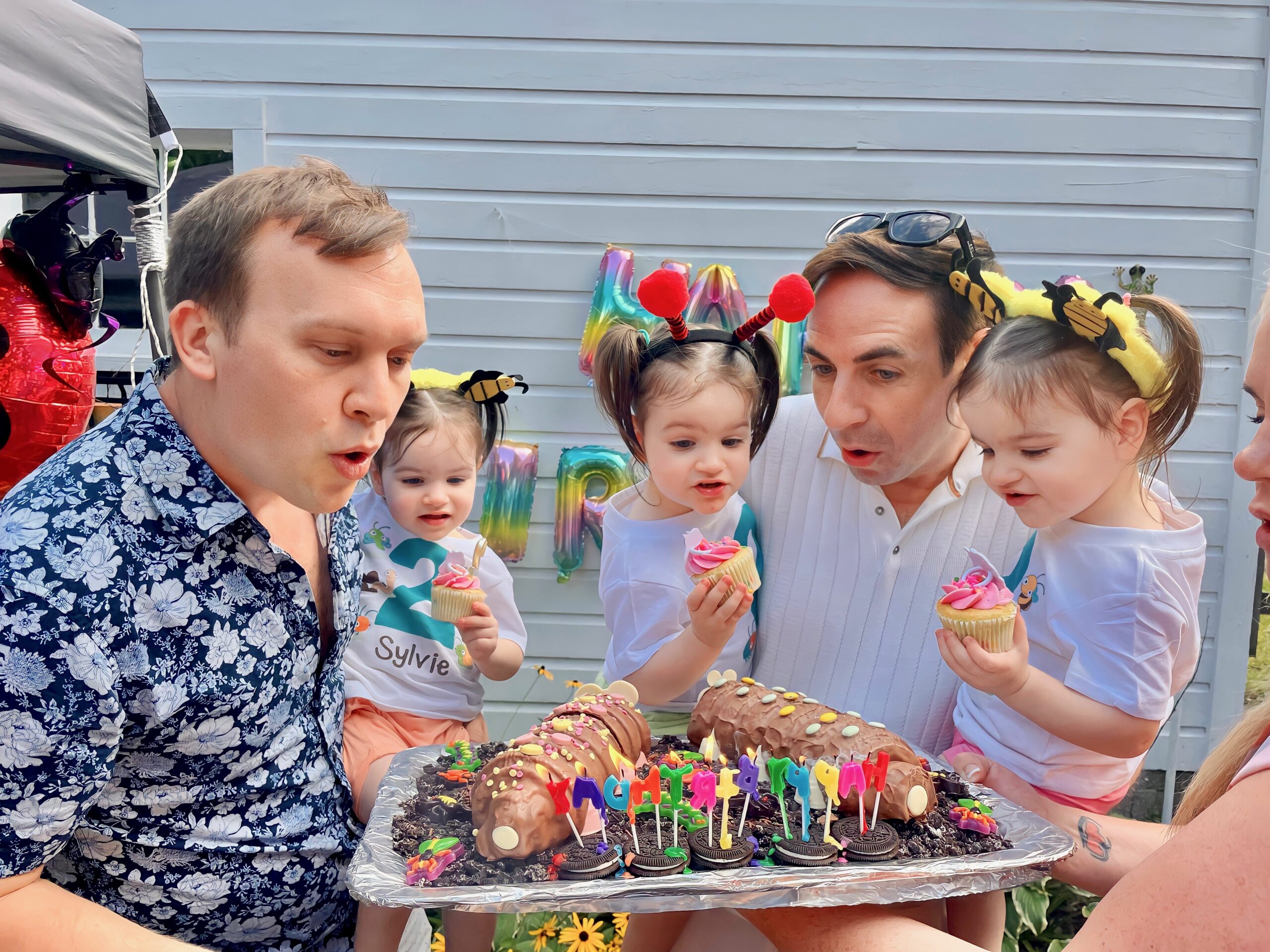 Eric Portenga and Kevin O'Neill with daughters Sylvie, Robin and Parker O'Neill celebrating the girls' 2nd birthday in Sept. 2023. The babies' surrogate lived in Ohio because of Michigan's laws, that are changing now.