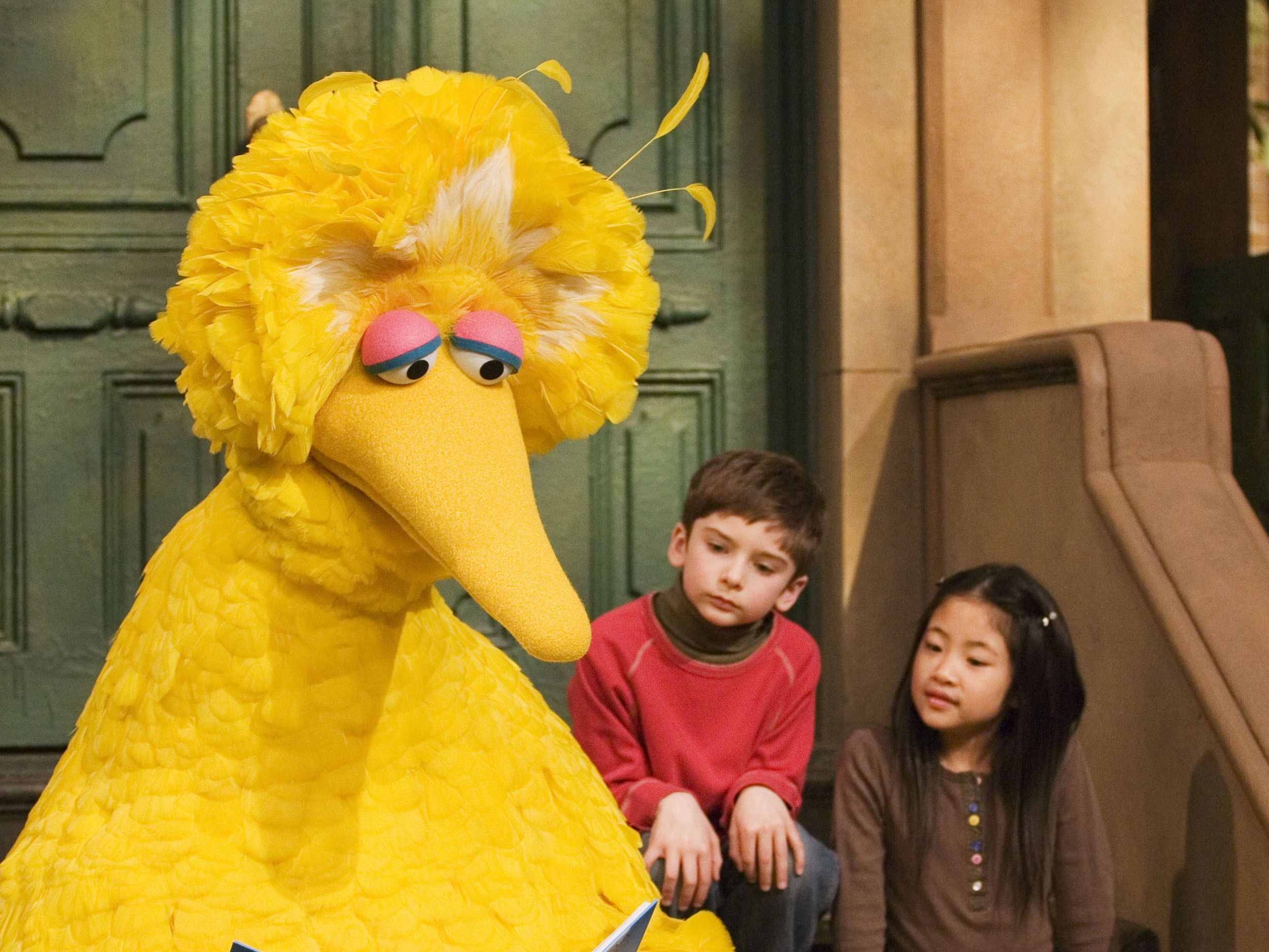 In this 2008 file photo, Big Bird reads to Connor Scott and Tiffany Jiao during a taping of Sesame Street in New York.