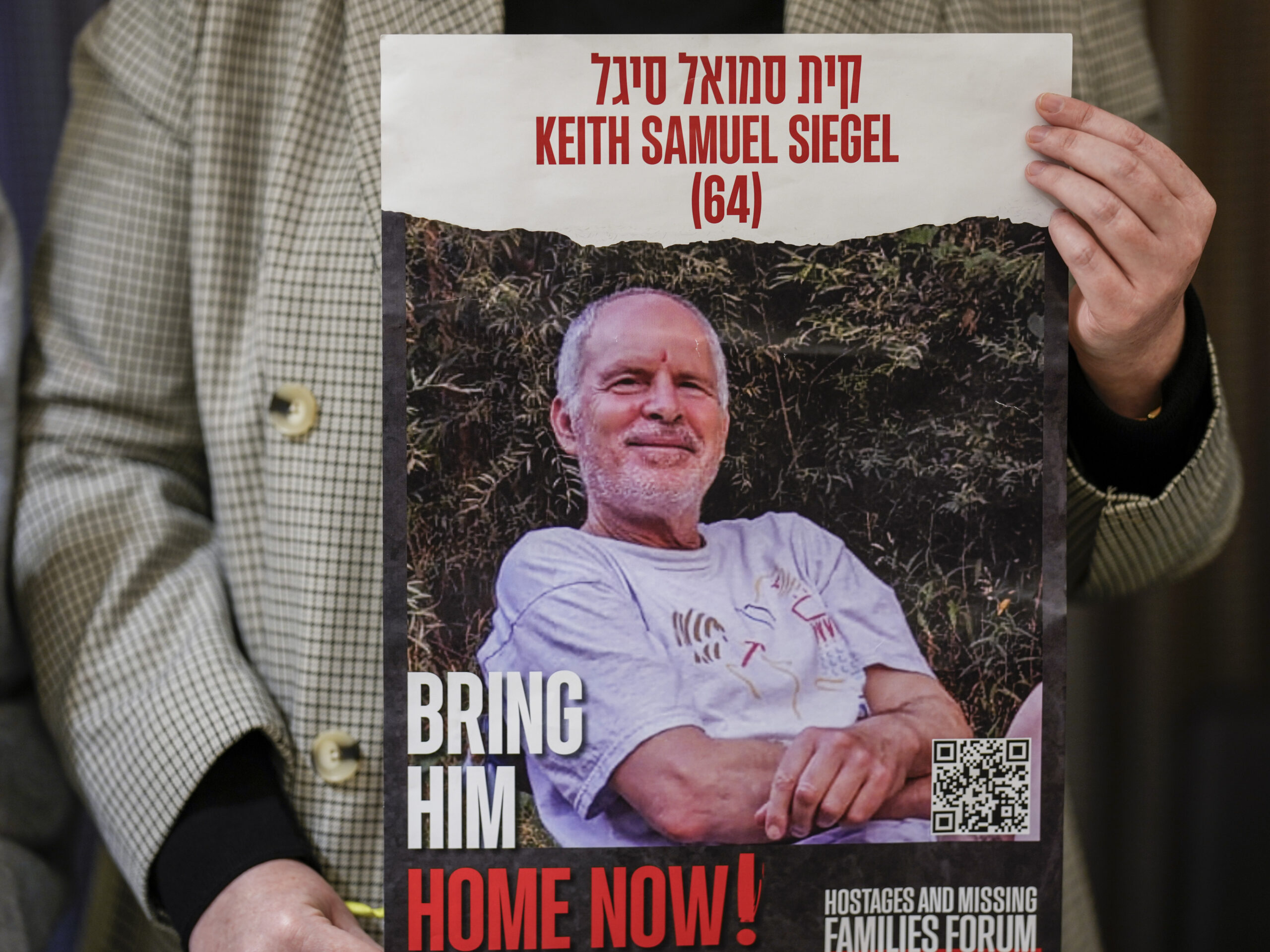 Tal Wax holds a poster with a photograph of her uncle Keith Siegel, a hostage held in Gaza since the Oct. 7 attacks, during a press conference in Madrid, Spain, on Jan. 25.