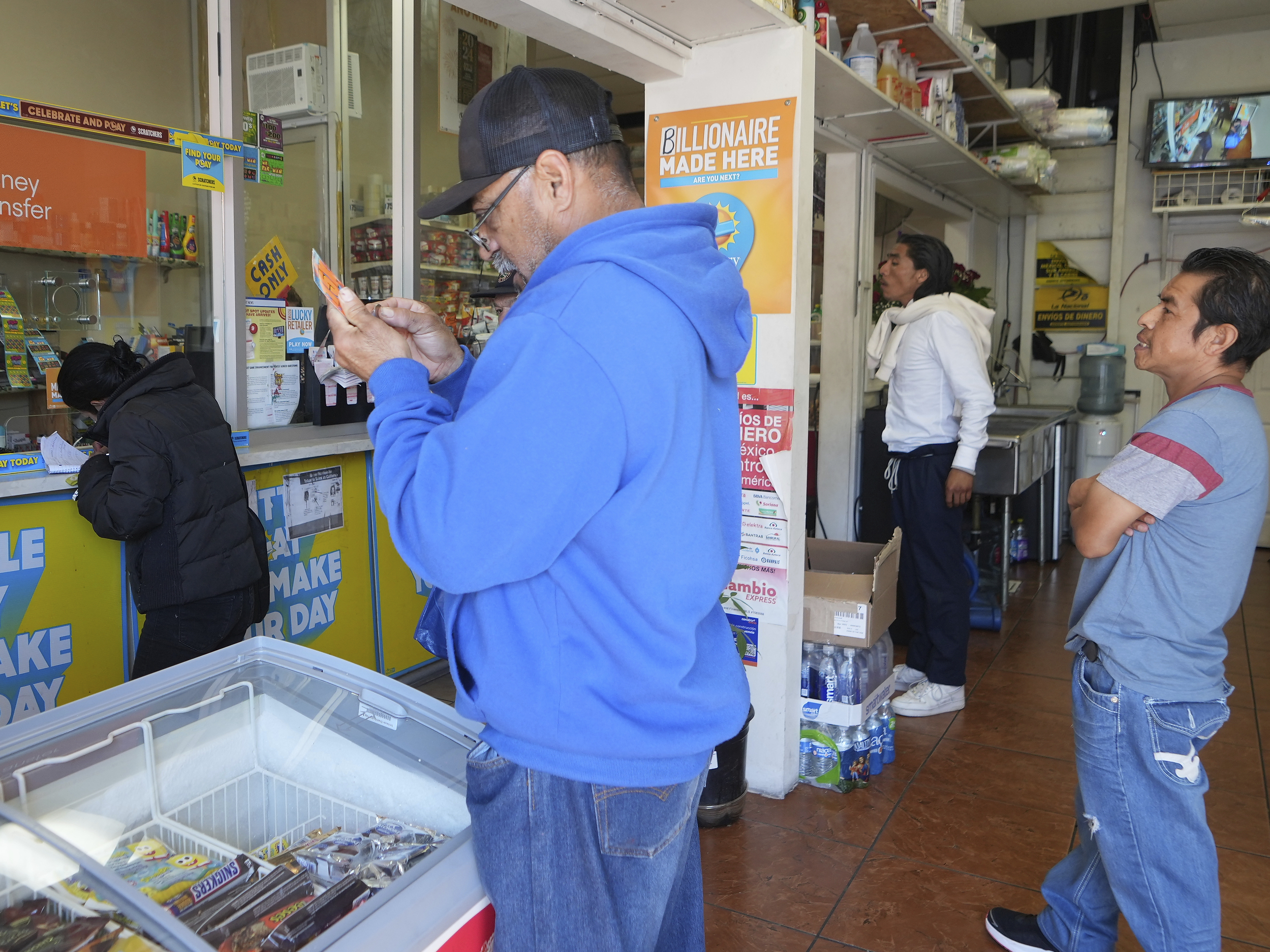 Lottery players buy Powerball tickets at the Las Palmitas Mini Market in in the Fashion District downtown Los Angeles on Monday, April 1, 2024.