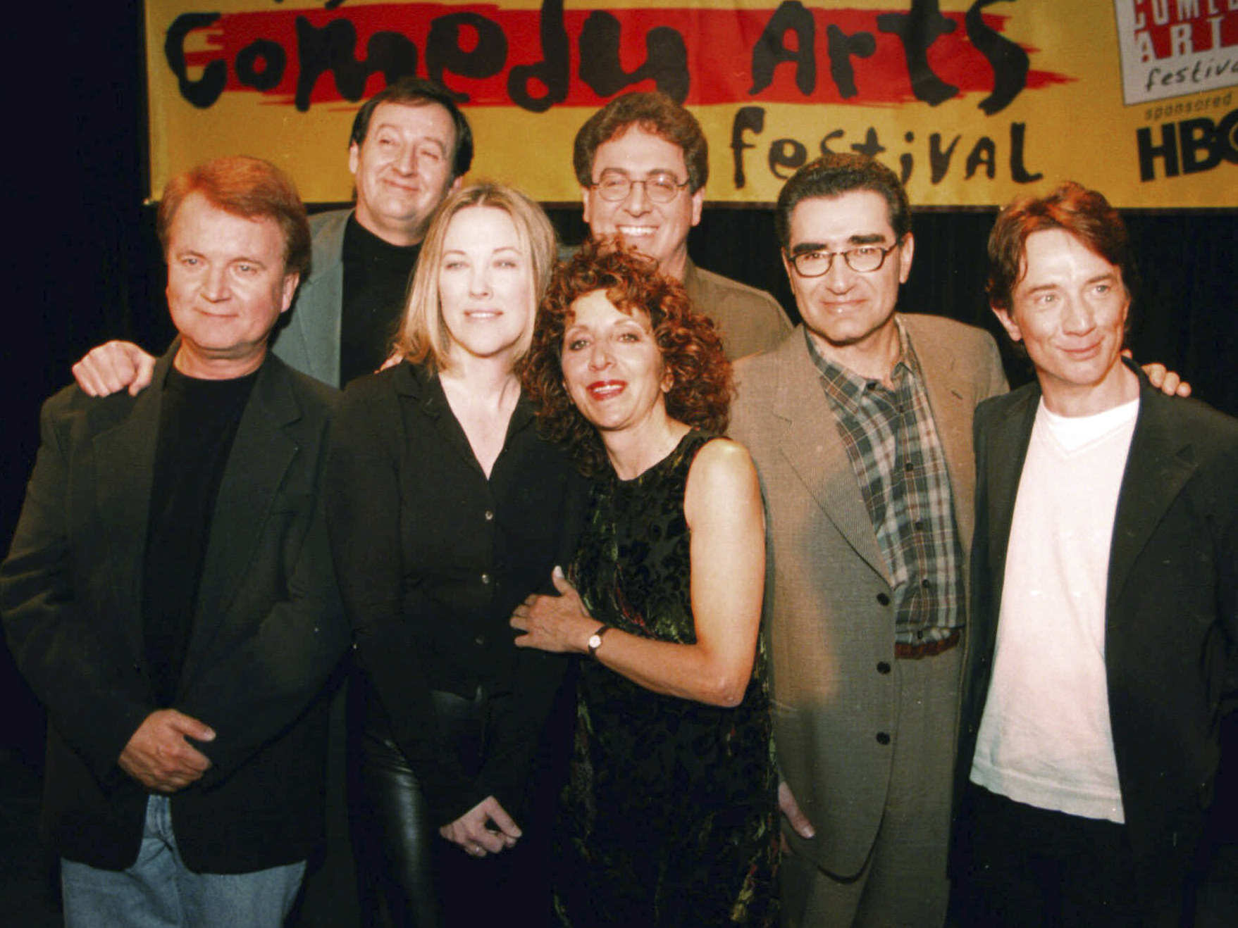 Former cast members of SCTV Dave Thomas (from left), Joe Flaherty, Catherine O'Hara, Andrea Martin, foreground, Harold Ramis, Eugene Levy and Martin Short, pose at the U.S. Comedy Arts Festival on March 6, 1999, in Aspen, Colo. Flaherty, a founding member of the Canadian sketch series "SCTV," died Monday at age 82.
