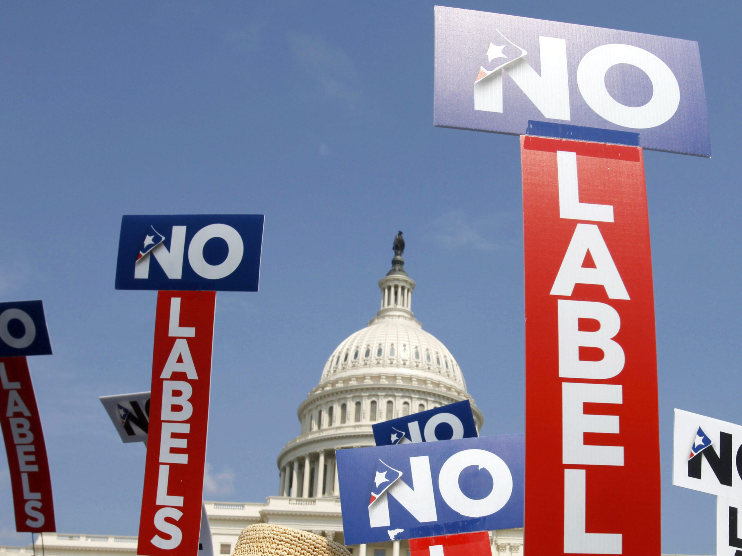 People with the group No Labels hold signs during a rally on Capitol Hill in 2013. The No Labels group says it won't field a presidential candidate in November after strategists for the bipartisan organization were unable to attract a candidate willing to seize on the widespread dissatisfaction with President Joe Biden and Donald Trump.