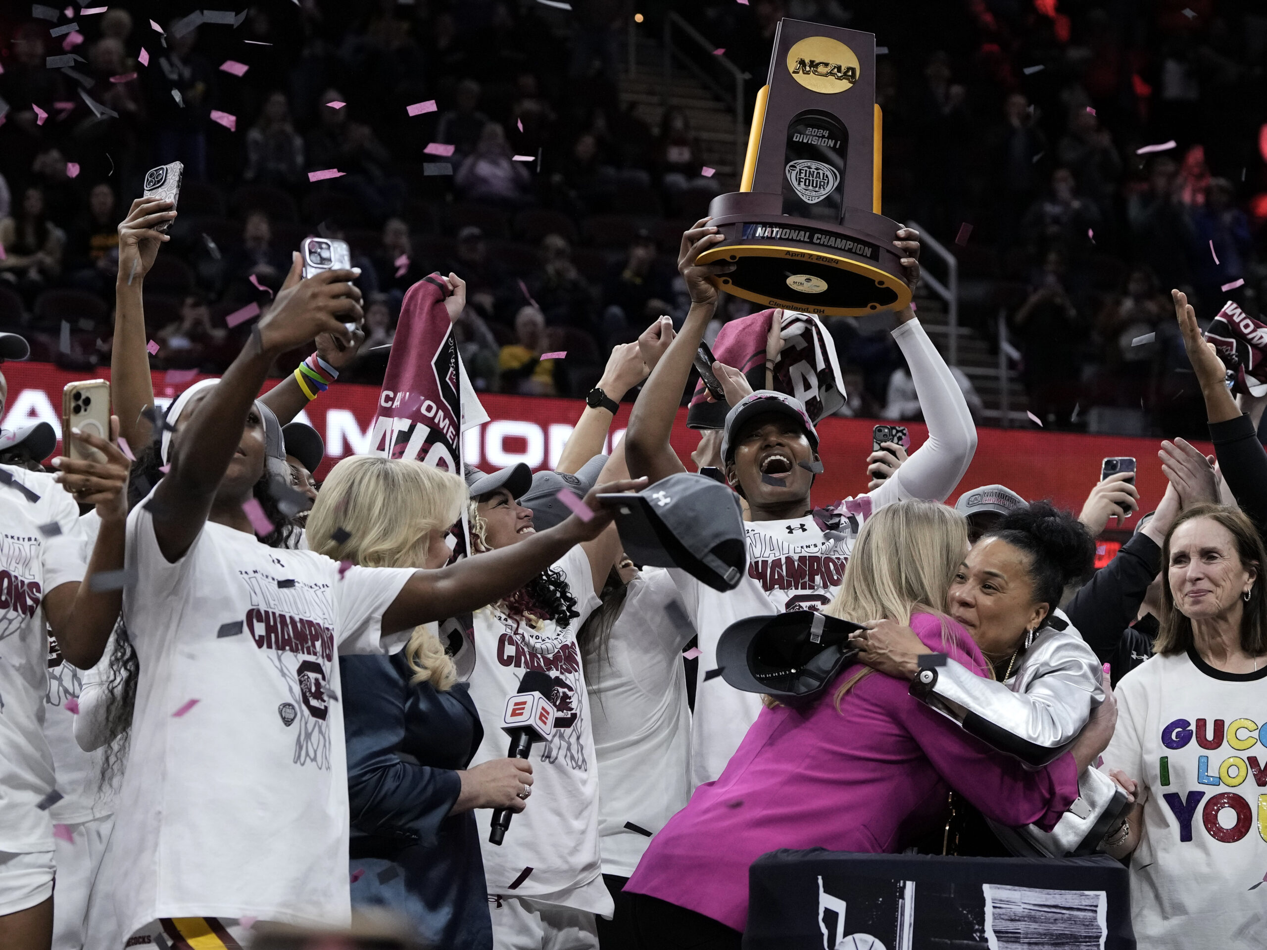 South Carolina's players and coach celebrate after the college basketball championship game against Iowa in the women's NCAA Tournament on Sunday. South Carolina won 87-75.