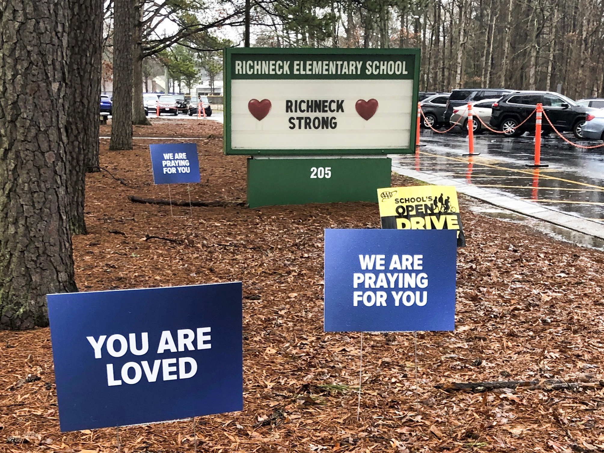 Signs stand outside Richneck Elementary School in Newport News, Va., Jan. 25, 2023.