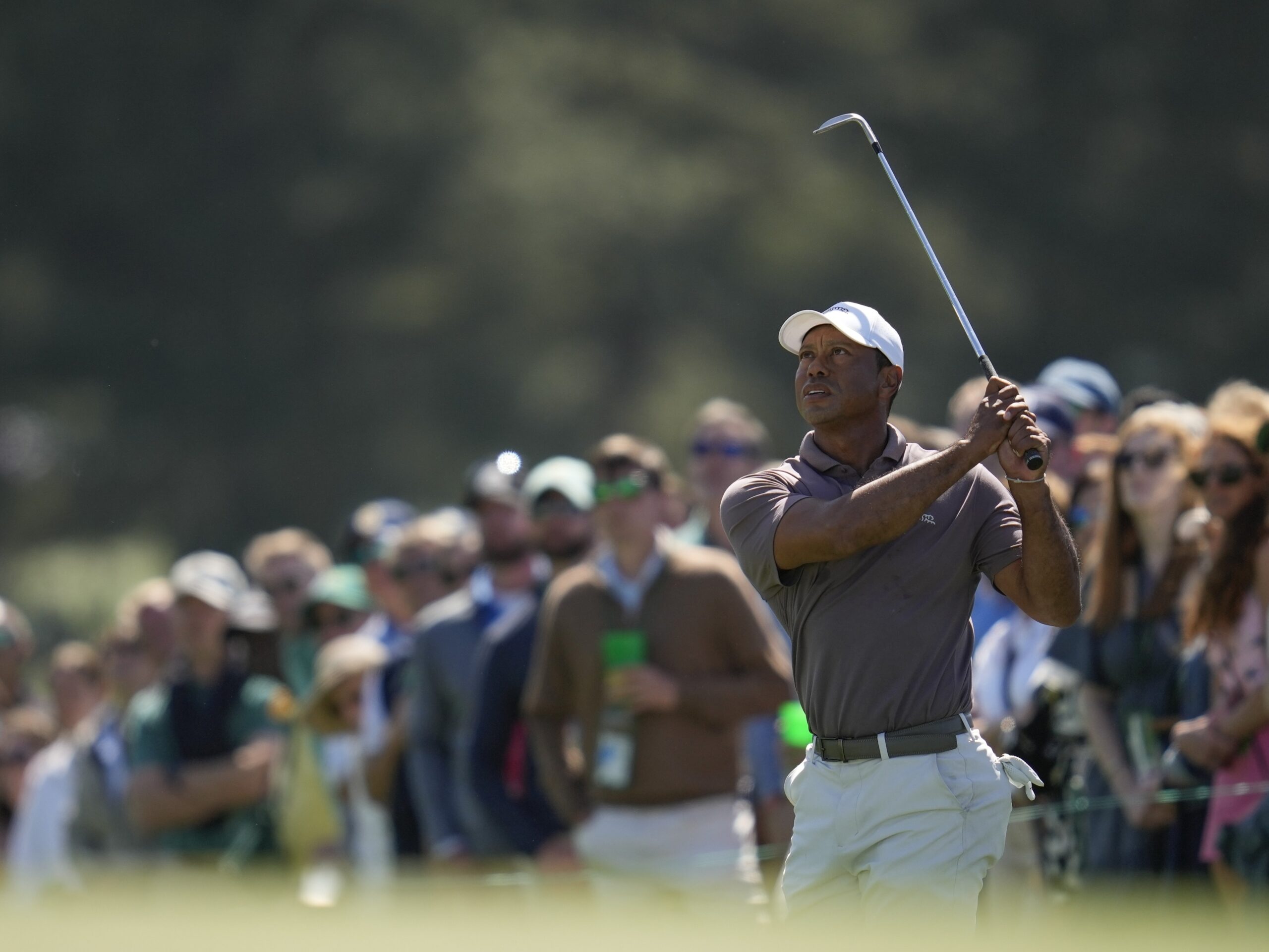 Tiger Woods watches his chip on the 18th hole Friday at the Masters tournament at Augusta National Golf Club in Augusta, Ga.
