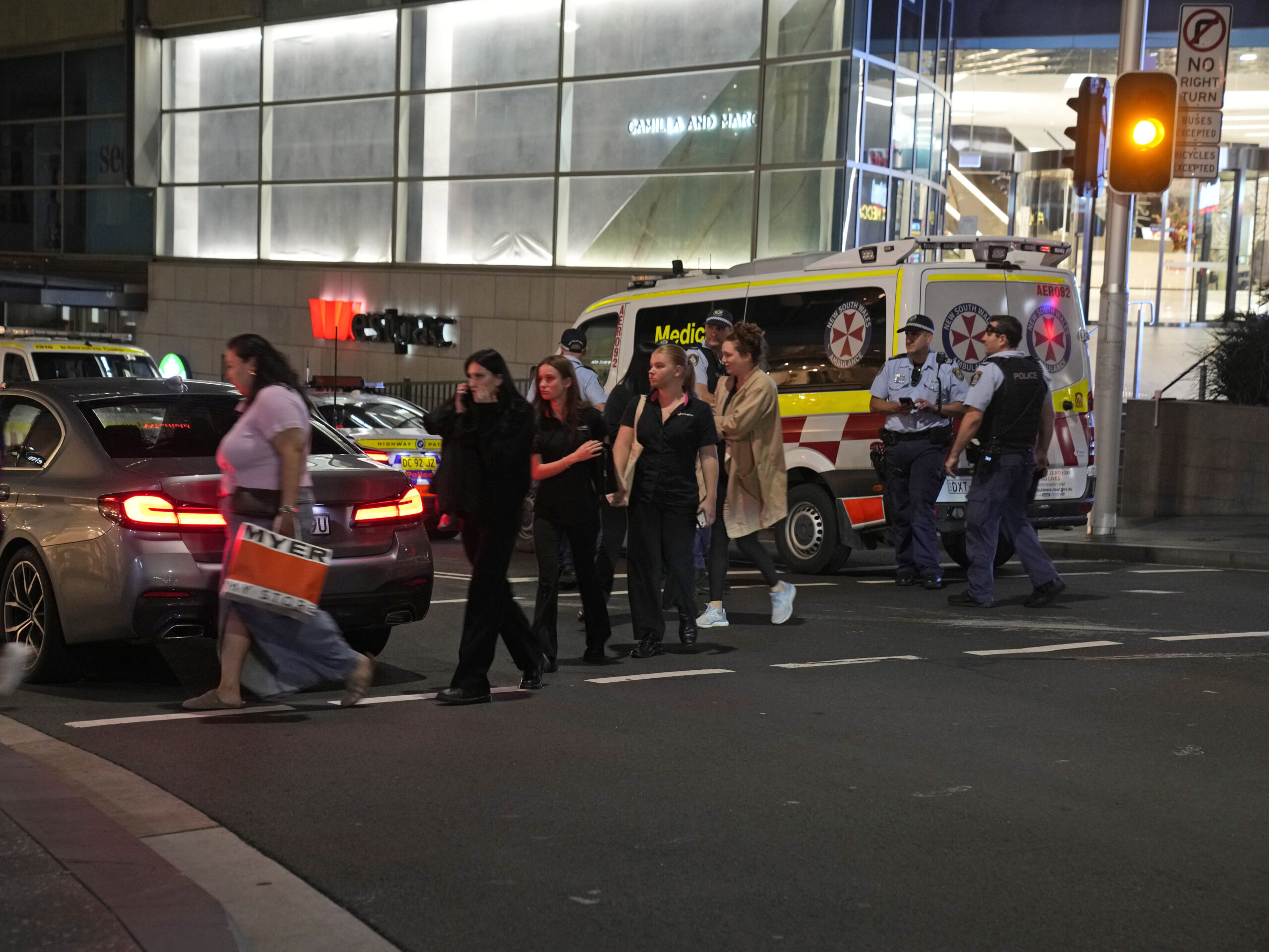 People are led out from the Westfield Shopping Centre where multiple people were stabbed in Sydney on Saturday.