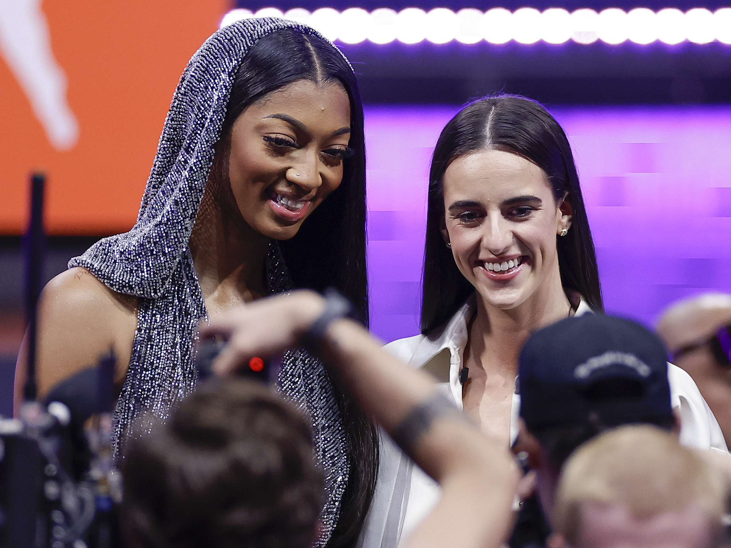 LSU's Angel Reese, left, and Iowa's Caitlin Clark, right, pose for a photo before the WNBA basketball draft, Monday, April 15, 2024, in New York.