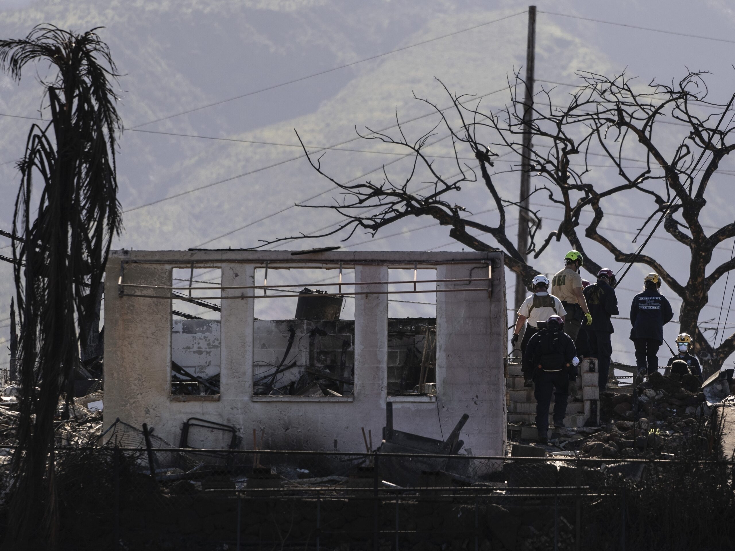 Search and rescue team members work in a residential area devastated by a wildfire in Lahaina, Hawaii, on Aug. 18, 2023.