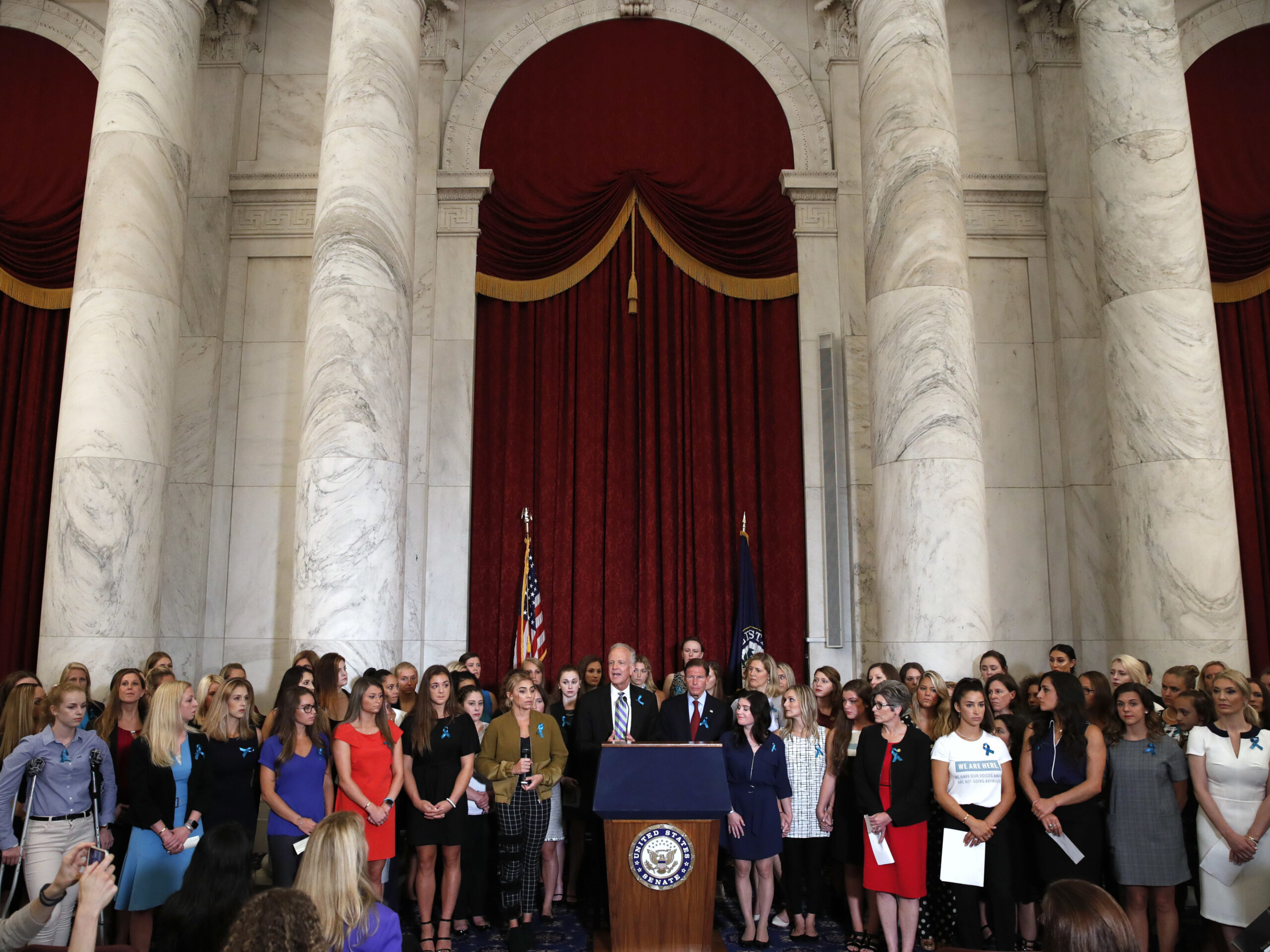 Sen. Jerry Moran, R-Kansas, center left, and Sen. Richard Blumenthal, D-Conn., attend a news conference with dozens of women and girls who were sexually abused by Larry Nassar, a former doctor for Michigan State University athletics and USA Gymnastics, July 24, 2018, on Capitol Hill in Washington.