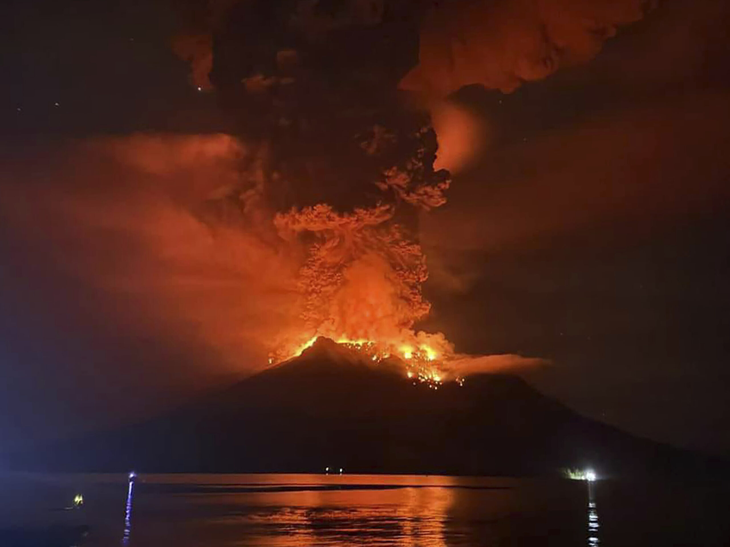 Indonesians leave homes near erupting volcano and airport closes due to ash danger