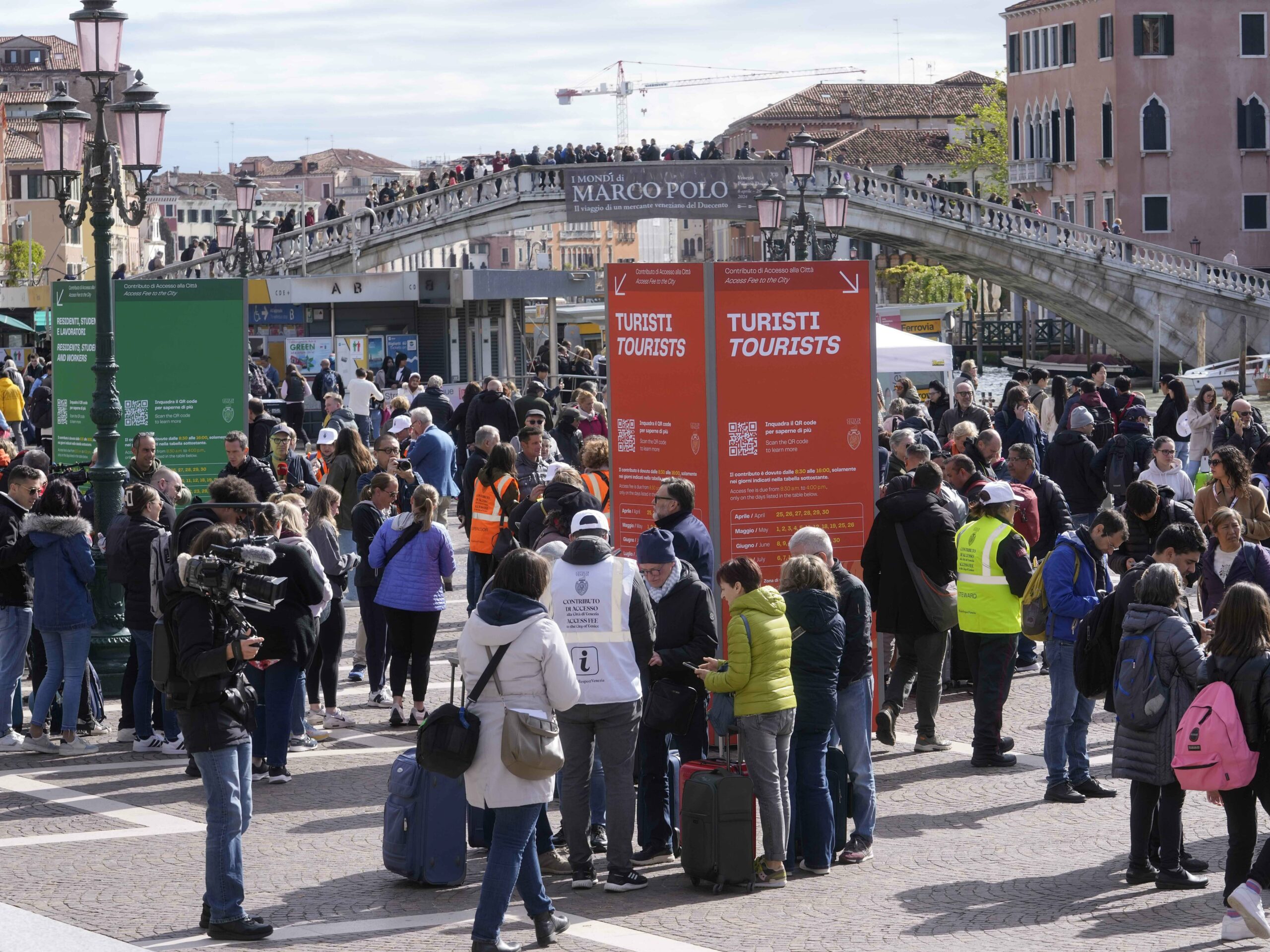 Stewards check tourists' QR code access outside the main train station in Venice, Italy, on Thursday.