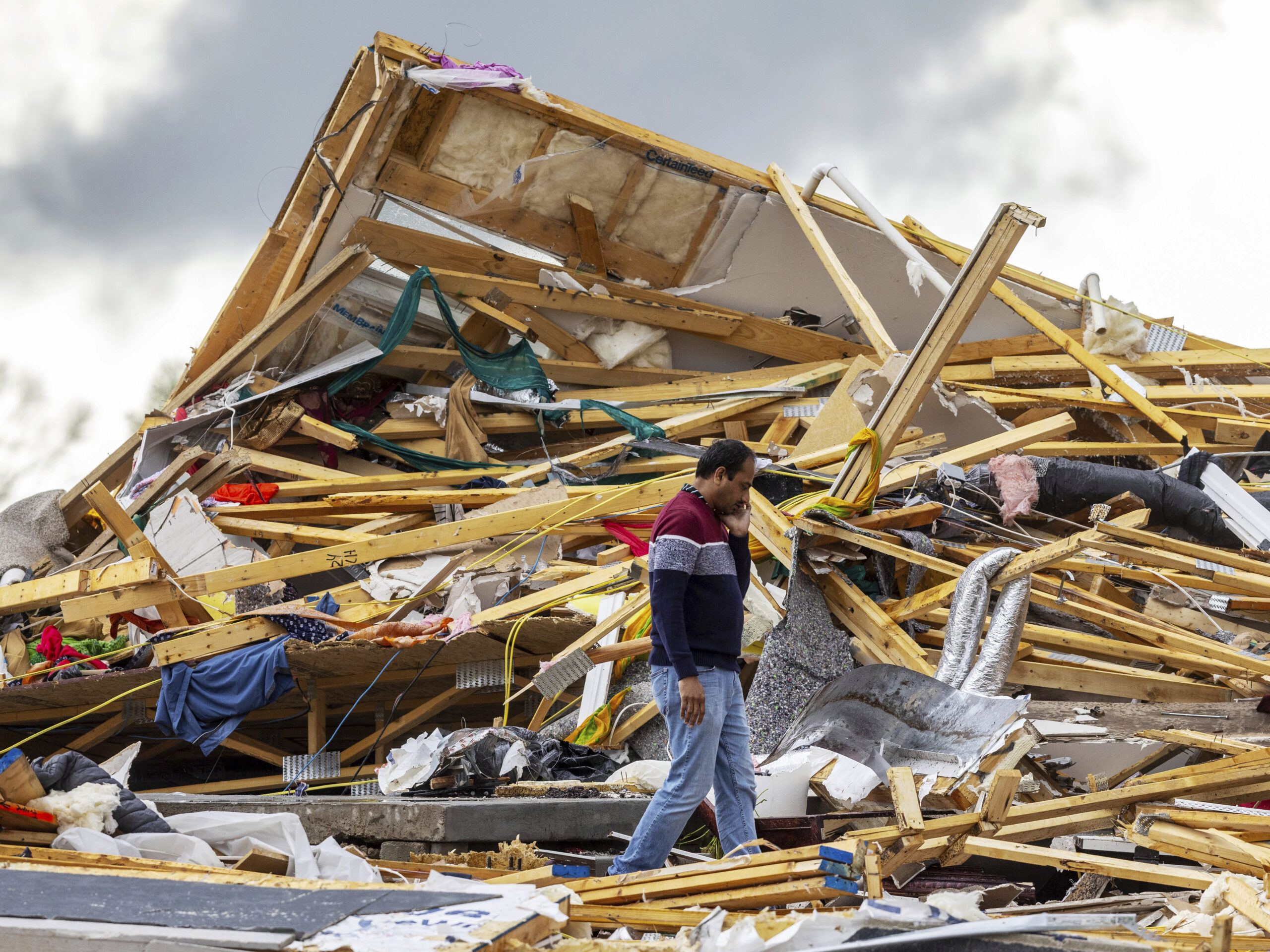 Gopala Penmetsa walks past his house after it was leveled by a tornado near Omaha, Neb., on Friday.
