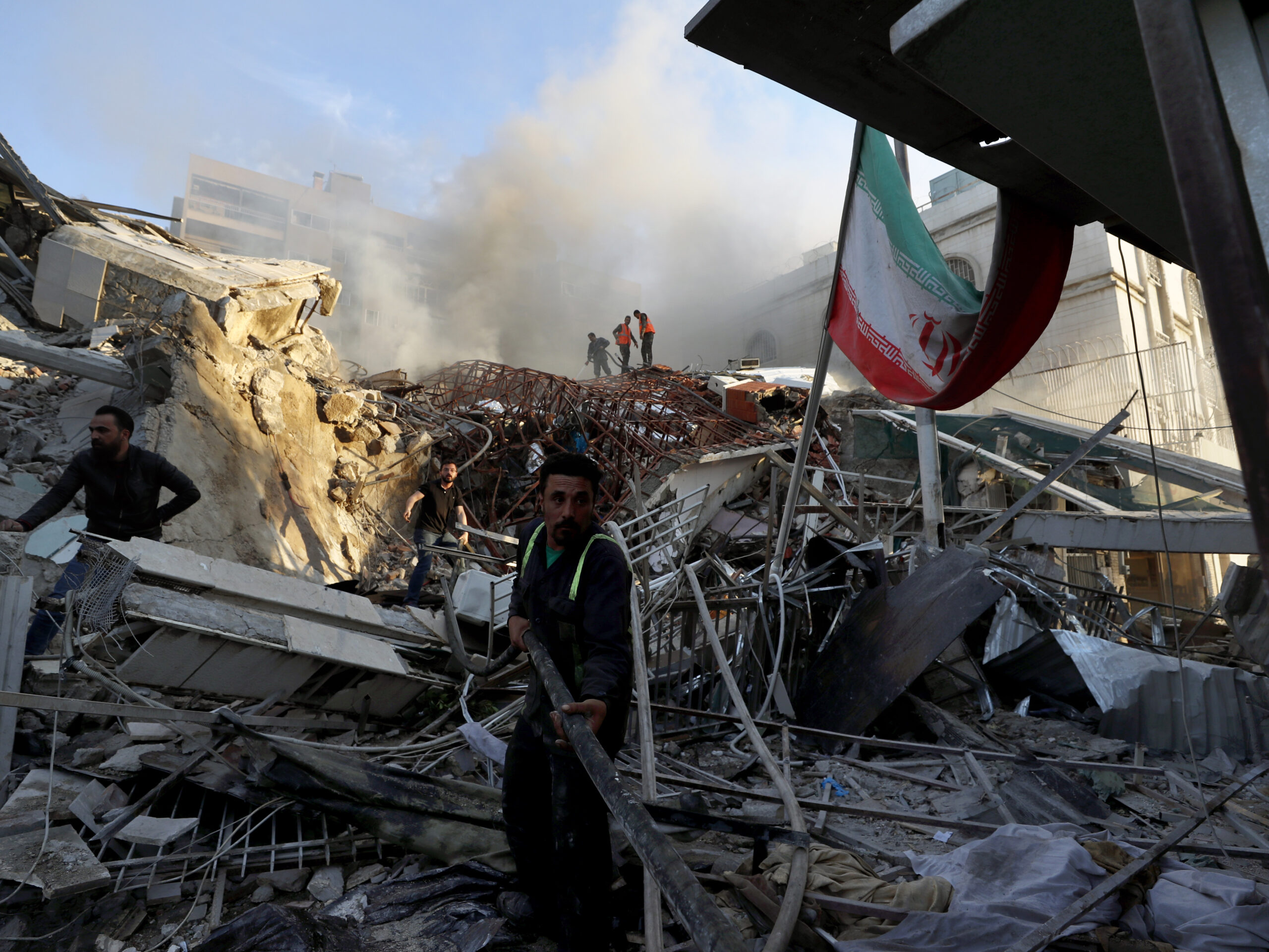 Emergency services work at a building hit by an air strike in Damascus, Syria, Monday.  Iran's consulate in Damascus was demolished and two Iranian generals were among those killed, Syrian and Iranian officials said.