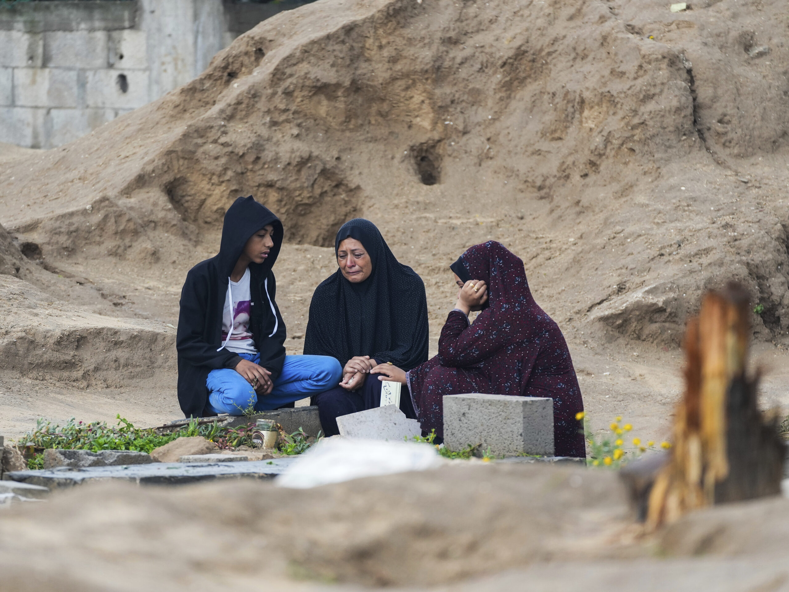 Palestinians visit the graves of  relatives killed in the war between Israel and Hamas. The cemetery is in the central Gaza town of Deir al-Balah. Wednesday marked the first day of the Muslim holiday of Eid al-Fitr, but it was a somber day throughout Gaza.