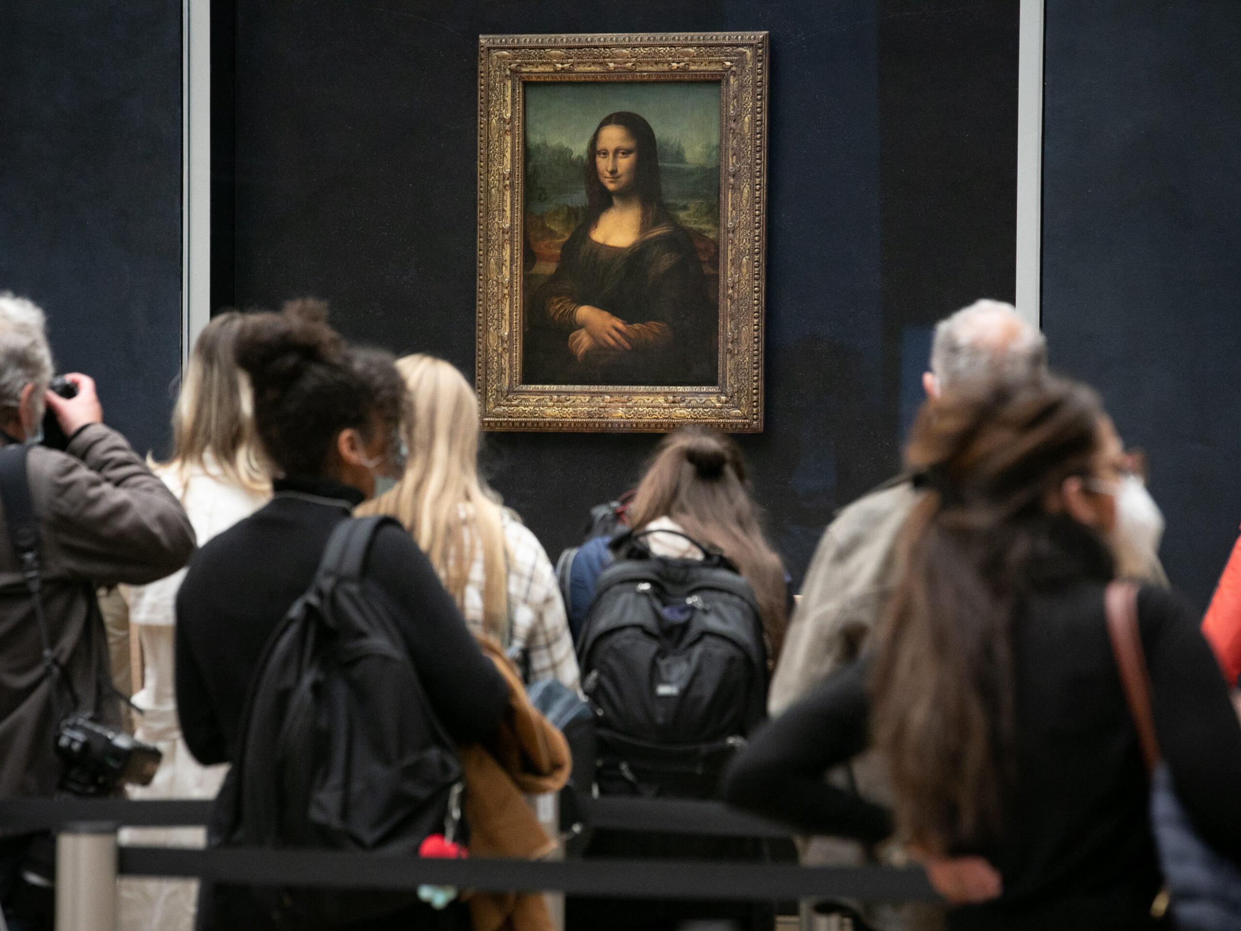 Visitors observe the painting the Mona Lisa by Italian artist Leonardo da Vinci on display in a gallery at Louvre on May 19, 2021 in Paris, France.