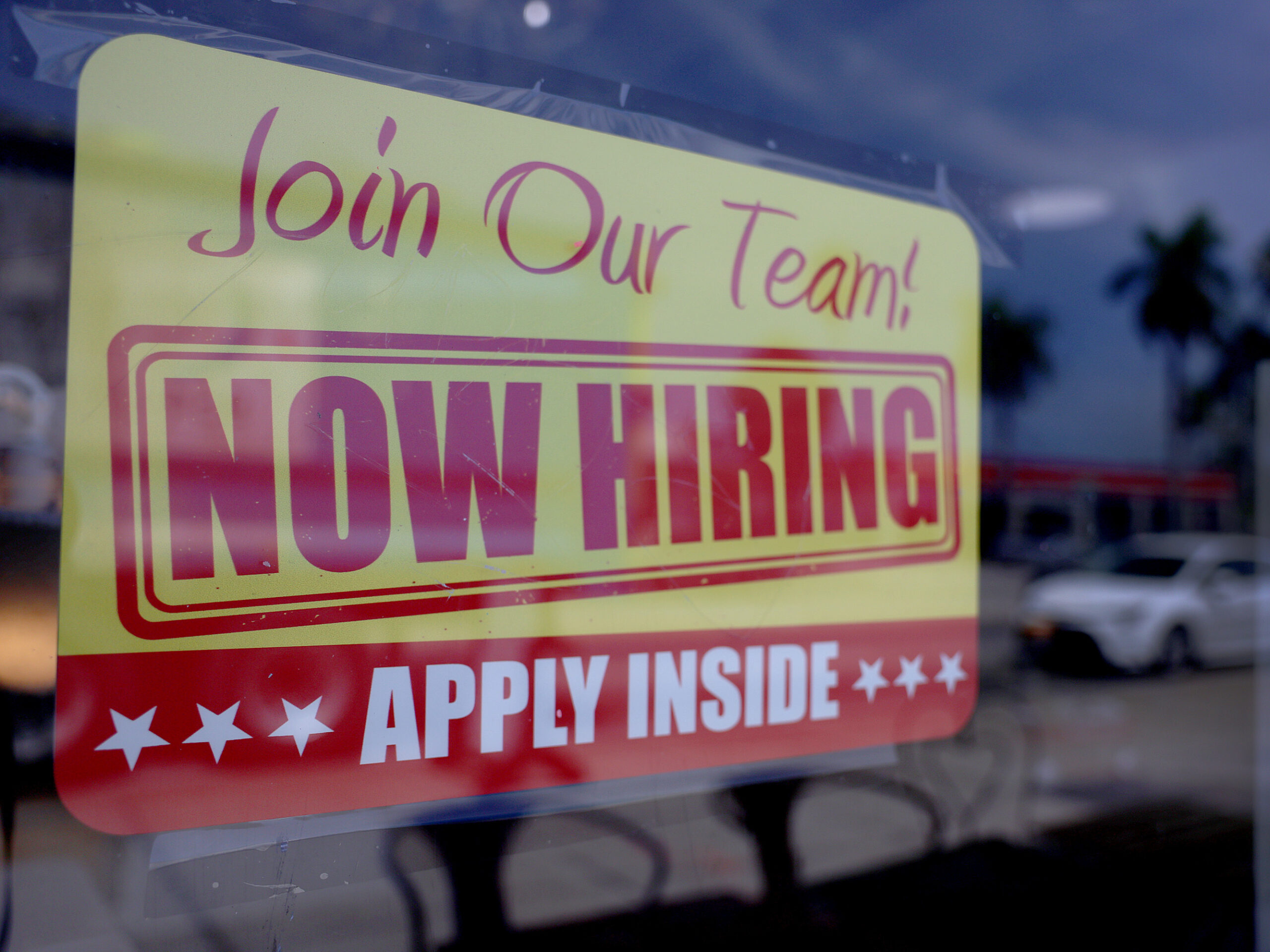A sign seeking job applicants is seen in the window of a restaurant in Miami, Florida, on May 5, 2023.