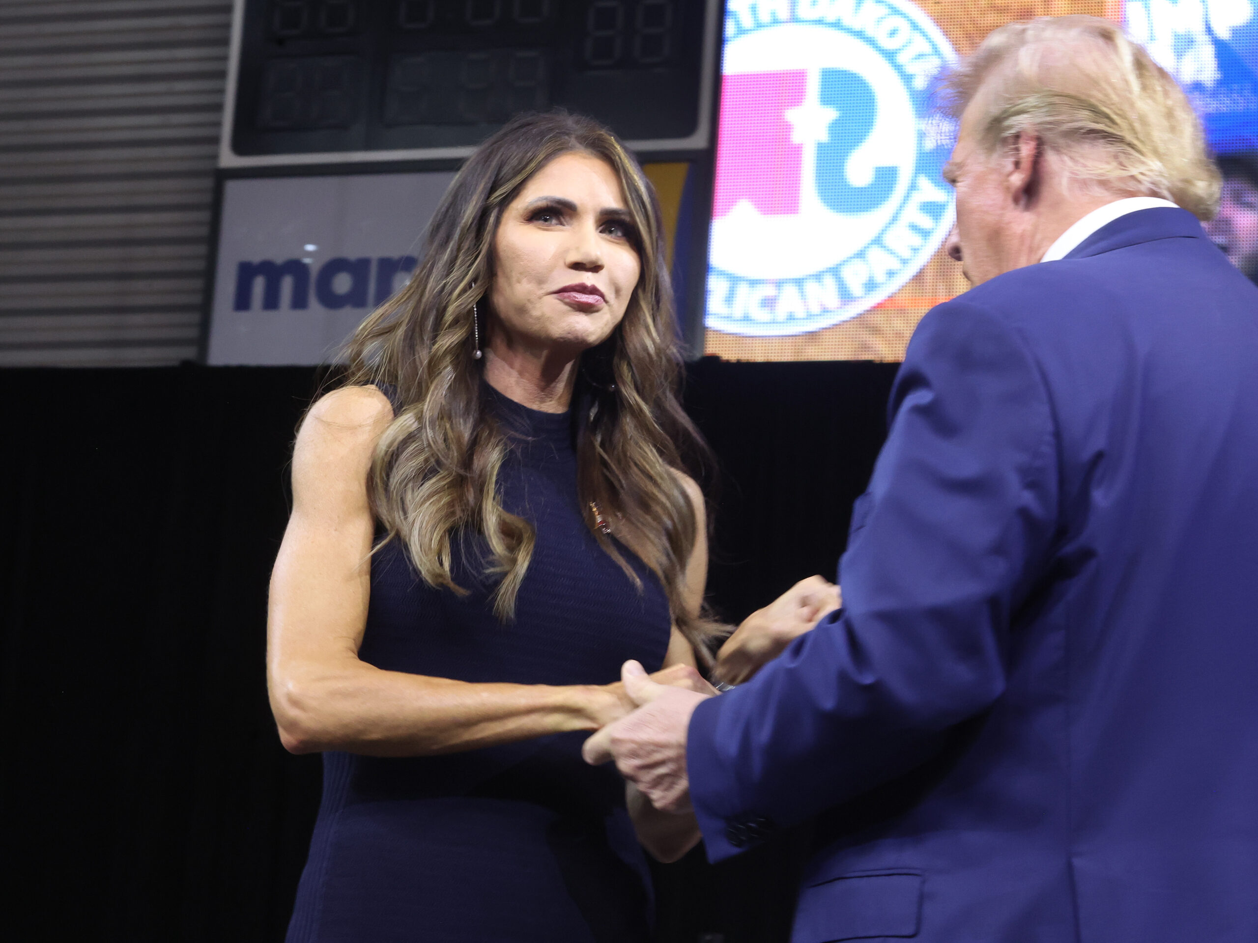 Former President Donald Trump greets South Dakota Gov. Kristi Noem at a rally hosted by the South Dakota Republican Party on Sept. 8 in Rapid City, S.D.