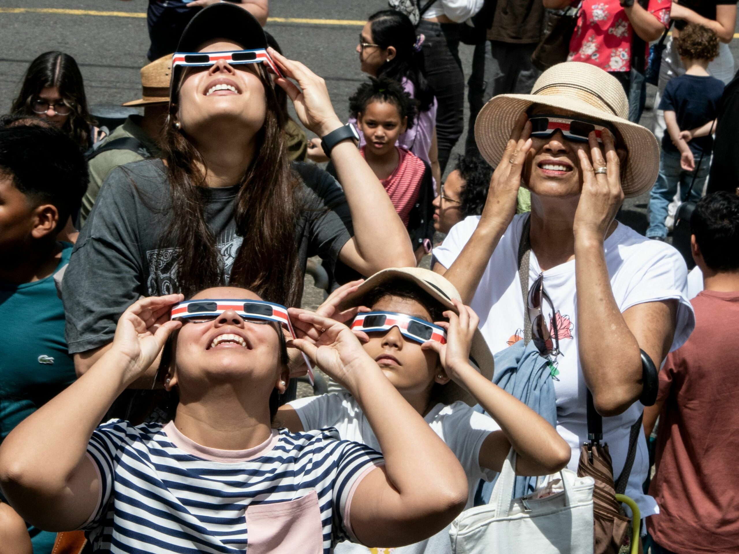 People watch the annular eclipse of the sun at the planetarium of the University of Costa Rica (UCR) in San Jose, on October 14, 2023.