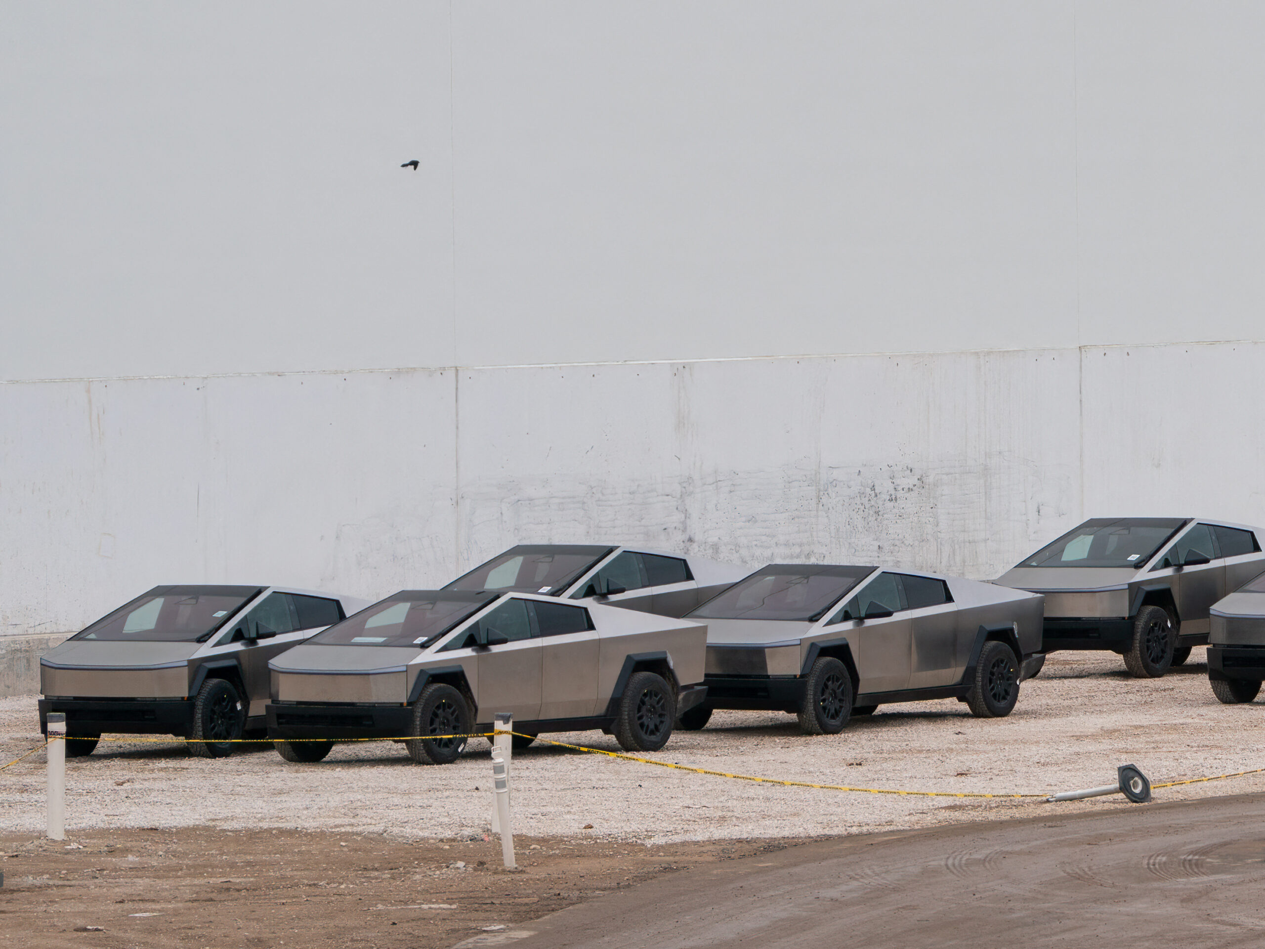 Newly manufactured Tesla Cybertrucks are parked outside the company's Giga Texas factory on December 13, 2023, in Austin, Texas.