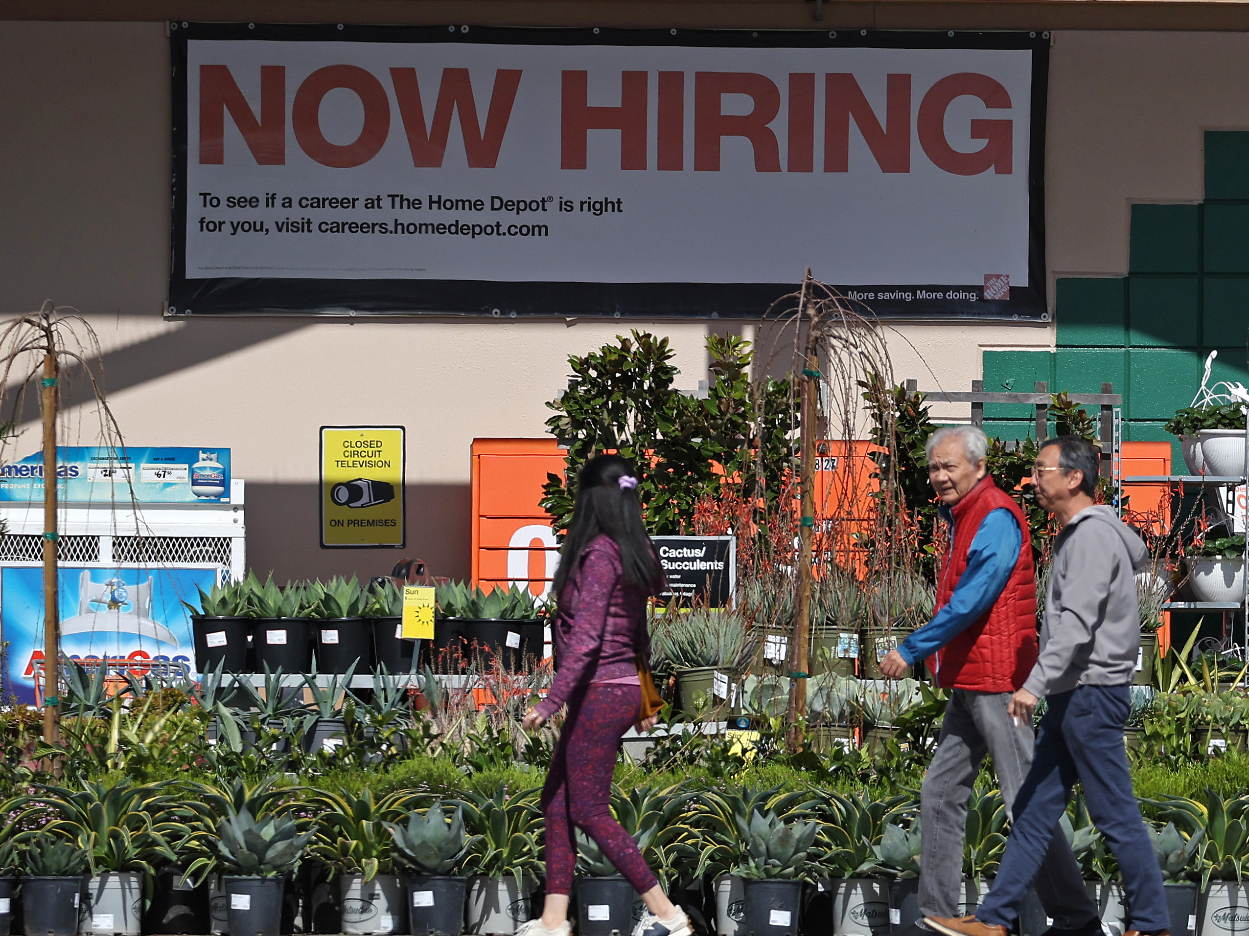 Hiring accelerated in the U.S. in March, adding 303,000 jobs, according to a report from the Bureau of Labor Statistics. The unemployment rate dipped to 3.8%, staying under 4% for more than two full years. People walk past a Home Depot in San Rafael, Calif.