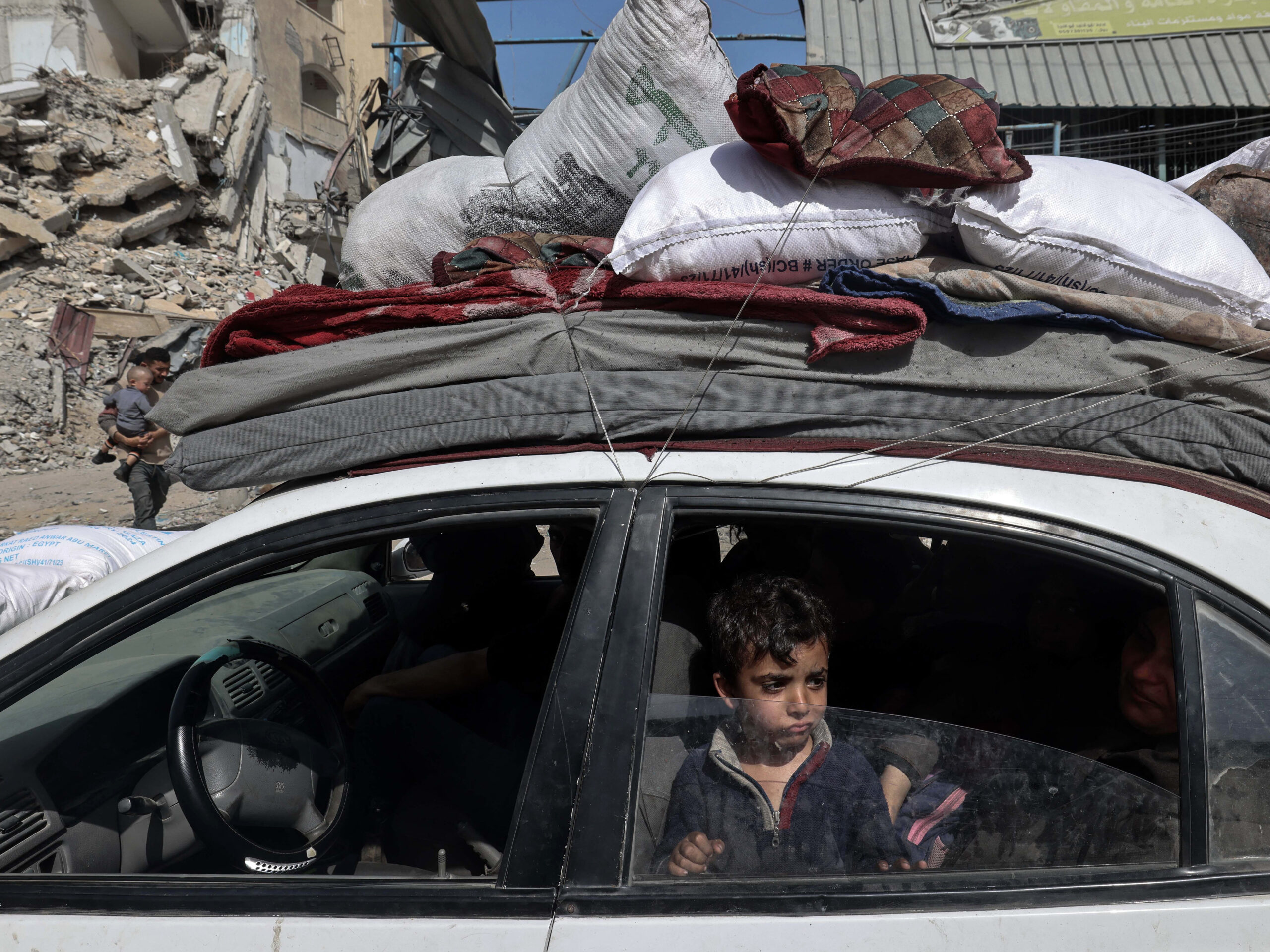 A young boy looks out from a car as members of a Palestinian family leave Rafah in the southern Gaza Strip with personal belongings on March 31.
