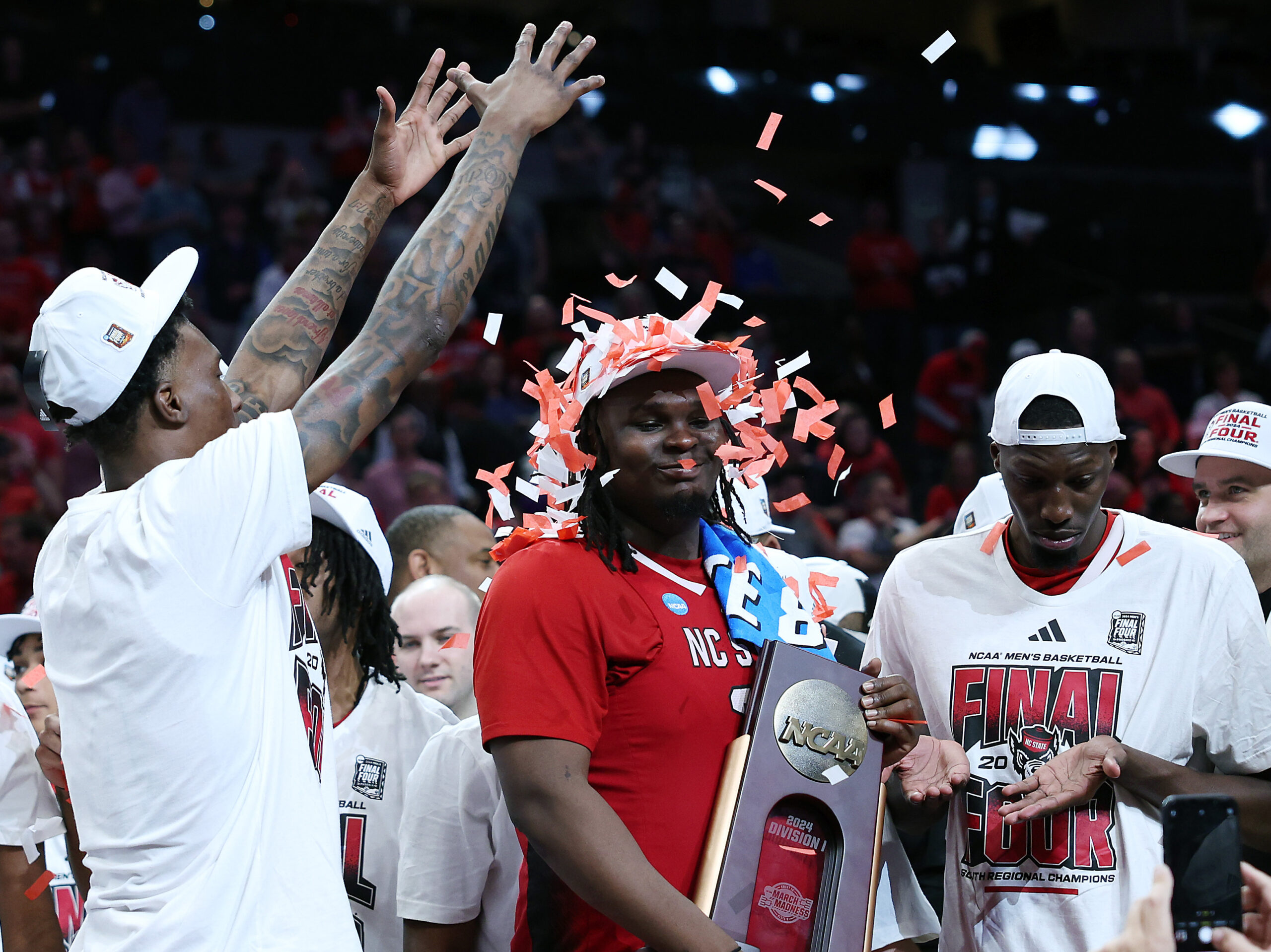 DJ Burns Jr. of the North Carolina State Wolfpack is showered with confetti after advancing to the Final Four.