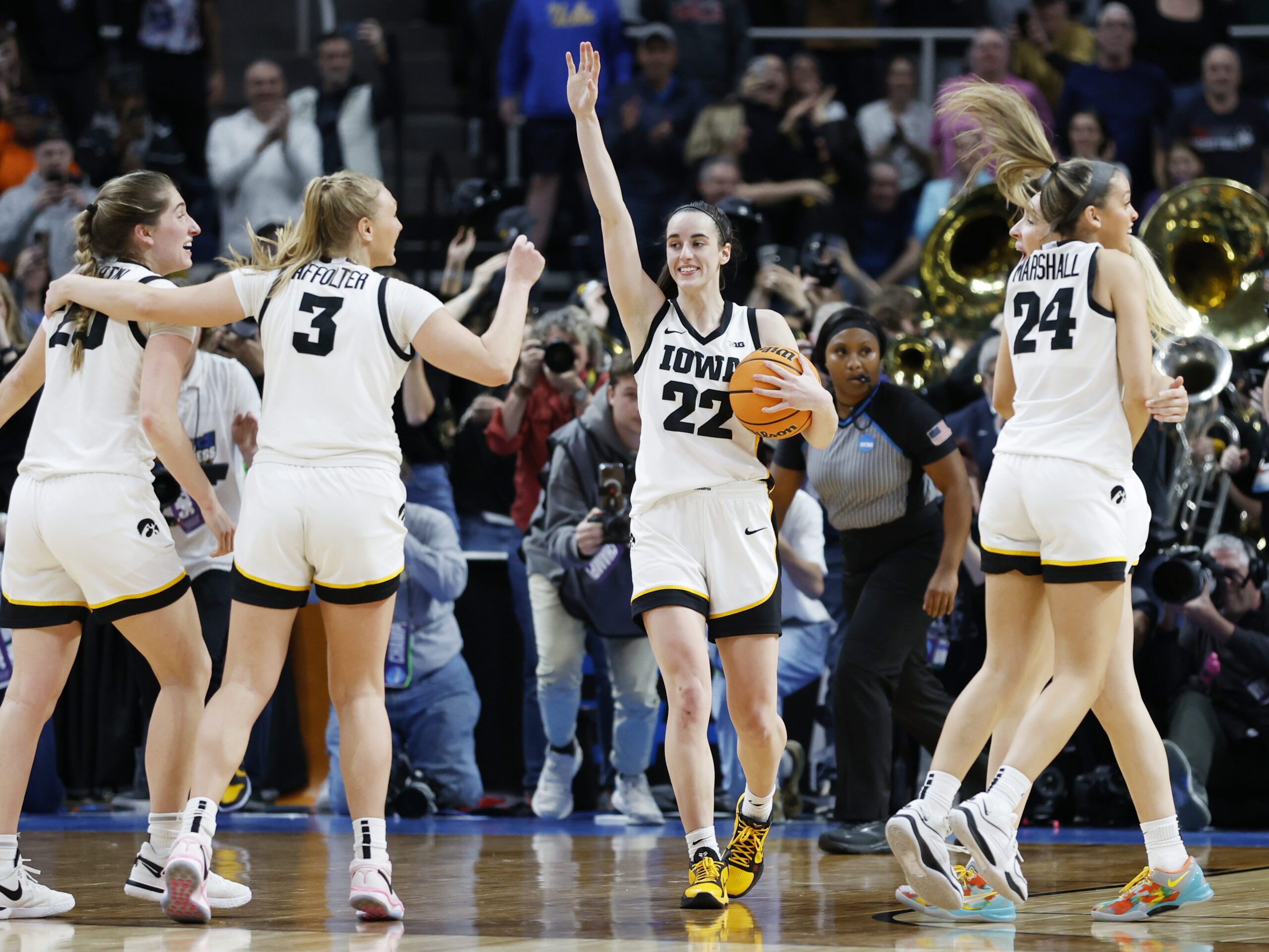 Caitlin Clark, #22 of the Iowa Hawkeyes, and her teammates celebrate after beating Louisiana State 94-87 in the Elite Eight round of the NCAA women's tournament on Monday.