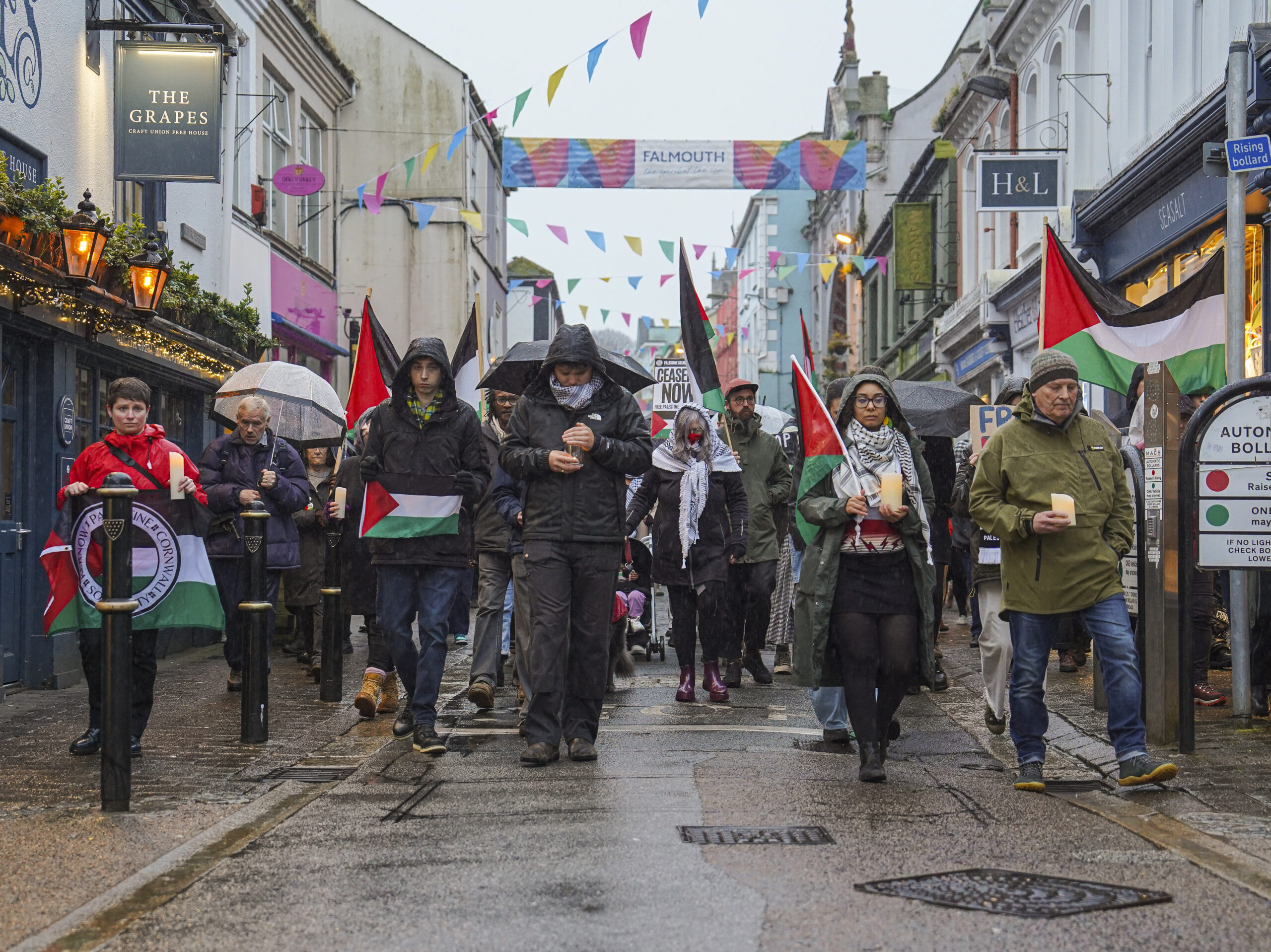 Members of the public join a walking vigil through the streets of Falmouth, England, for British aid worker James Henderson, organized by Palestine Solidarity Cornwall, April 3. Three British men working for World Central Kitchen were killed along with four colleagues when their clearly marked vehicles were targeted by Israeli military strikes.