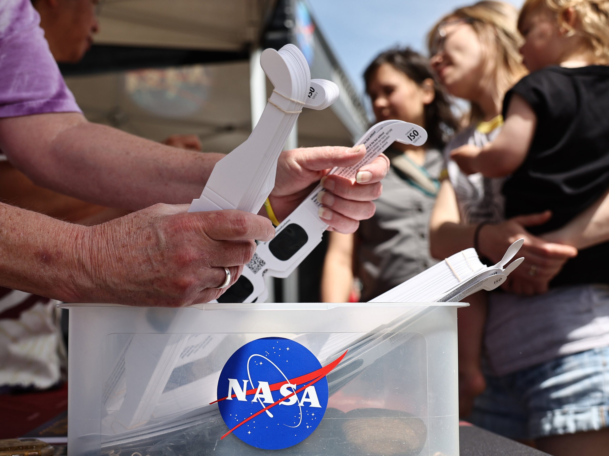 People visit a NASA information booth to grab solar eclipse glasses in Russellville, Arkansas. The space agency has debunked a number of myths about the total solar eclipse — including ideas about food going bad, or unborn babies being harmed.
