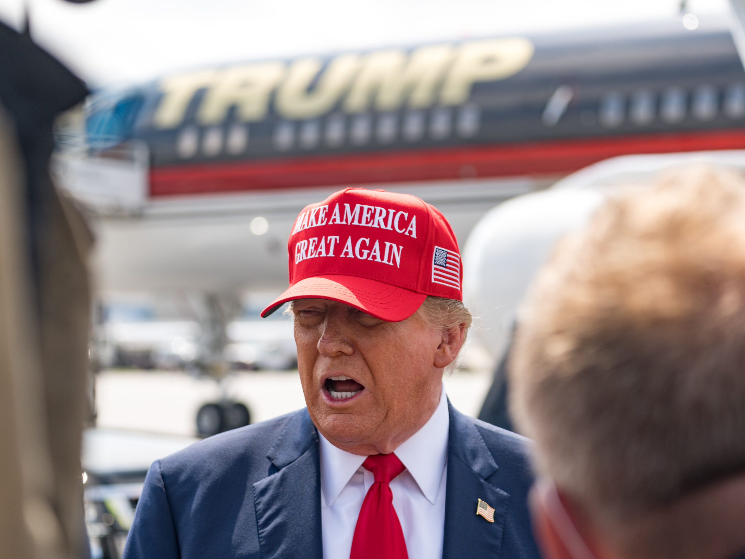 Former President Donald Trump speaks to the media as he arrives at the airport on Wednesday in Atlanta, Georgia. Trump is visiting Atlanta for a campaign fundraising event he is hosting.