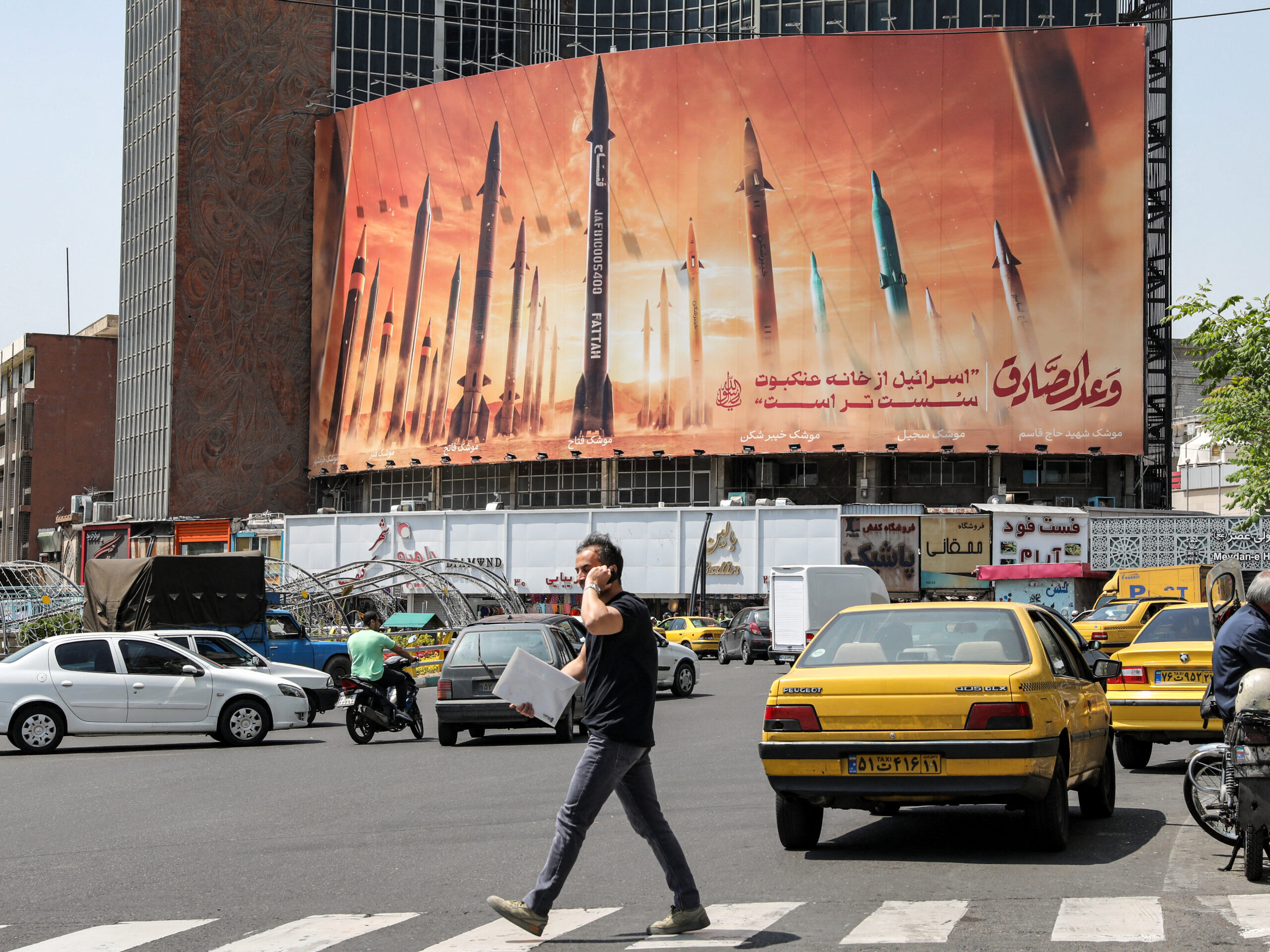 A billboard in central Tehran, Iran, depicts named Iranian ballistic missiles in service, with text in Arabic reading "the honest [person's] promise" and text in Persian reading "Israel is weaker than a spider's web," on April 15. Iran attacked Israel over the weekend with missiles, which it said was a response to a deadly strike on its consulate building in Damascus, Syria.