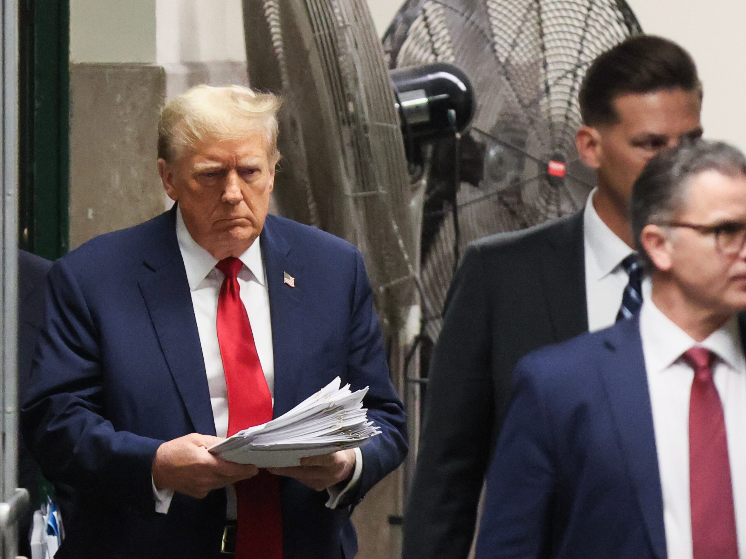 Former President Donald Trump, left, following a recess at Manhattan criminal court in New York on Tuesday.