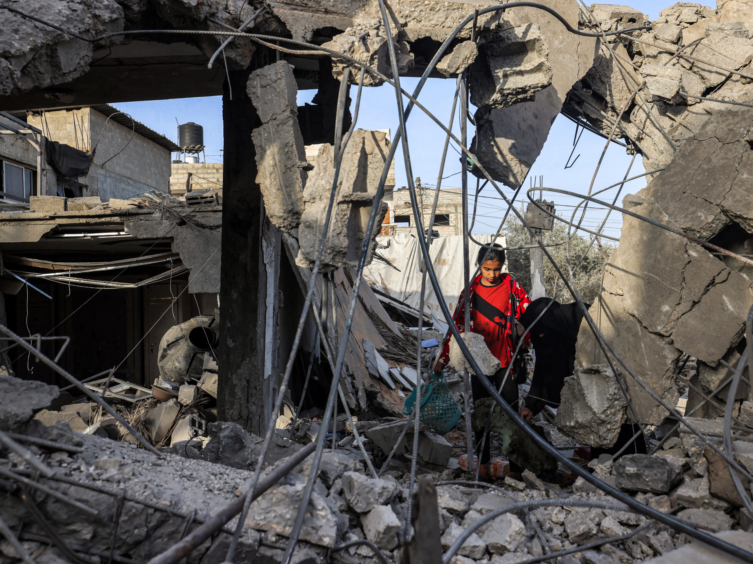 Amid the rubble of a collapsed building in Rafah, in southern Gaza, a woman and a girl search for items on April 24, following reported Israeli airstrikes overnight.