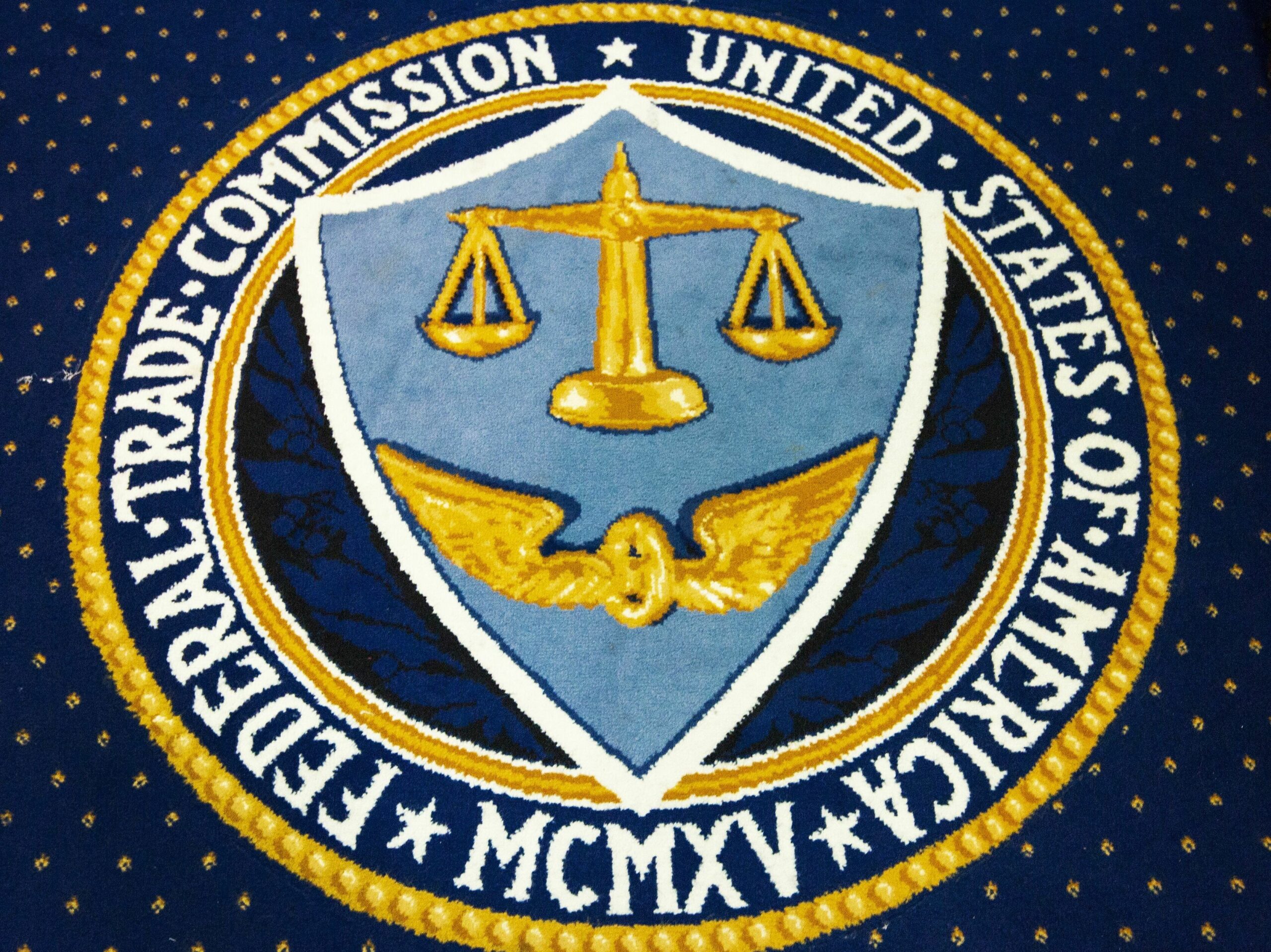 A 2014 file photo of the seal of the Federal Trade Commission in a carpet a FTC headquarters in Washington, DC. The organization is trying to raise consumer awareness about the use of artificial intelligence tools to create convincing audio deepfakes.