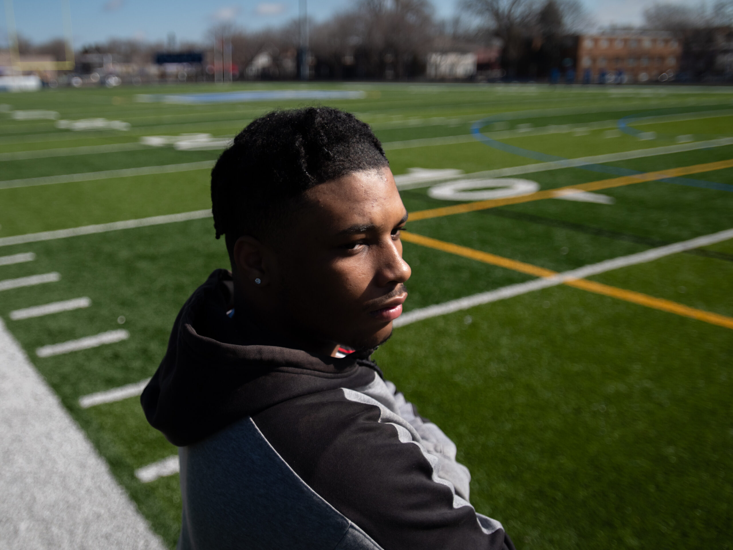Kahlil Brown, 18, says teammate Deshaun Hill Jr., the student and quarterback who was shot and killed in 2022, was his best friend. Brown, shown posing for a portrait at the North Community High School football field in Minneapolis on April 9, will attend St. Olaf College in the fall.