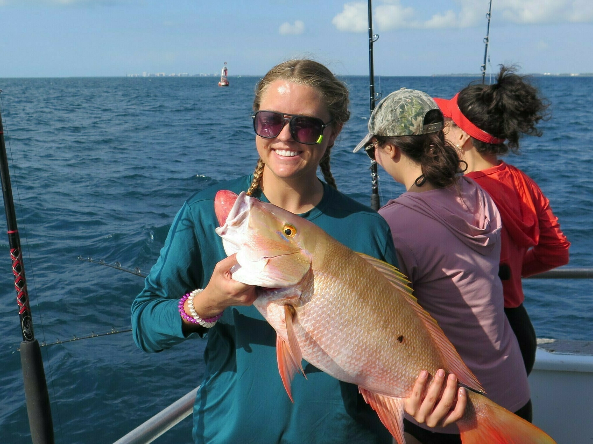 University of Miami Marine Sciences student Lauren Hayes with her catch, a 7 or 8 pound mutton snapper, which was released and returned to its reef habitat more than 100 feet below the surface.