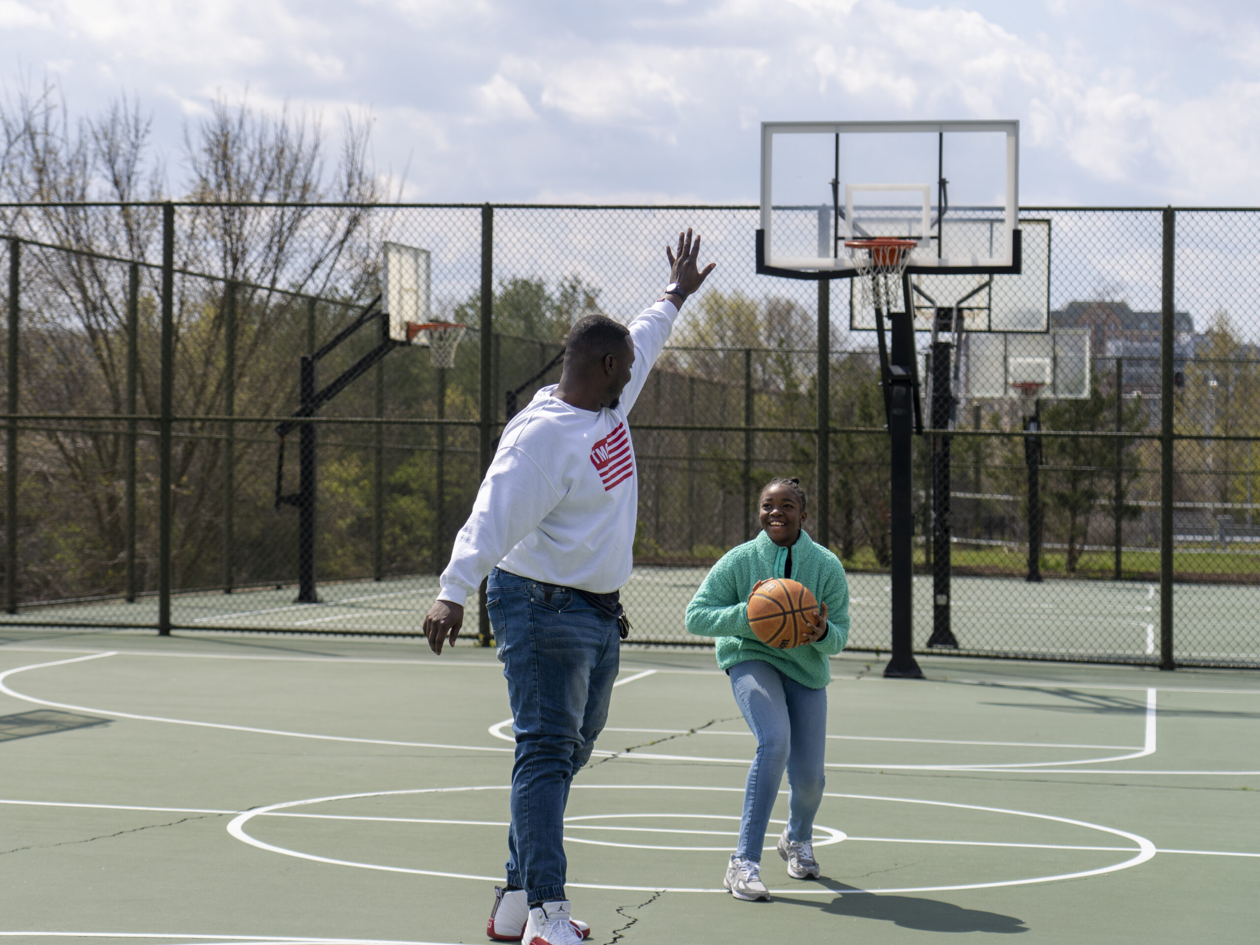 Joseph Yusuf plays basketball with his daughter, Jakayla Morton, 11, in Alexandria, Va., on March 29.