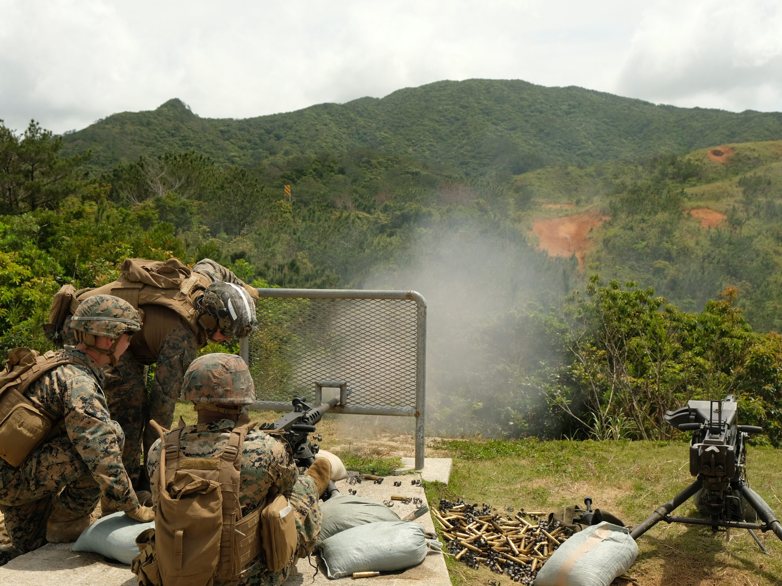Marines of the 12th Marine Littoral Regiment practice with .50-caliber machine guns on a firing range on Okinawa.