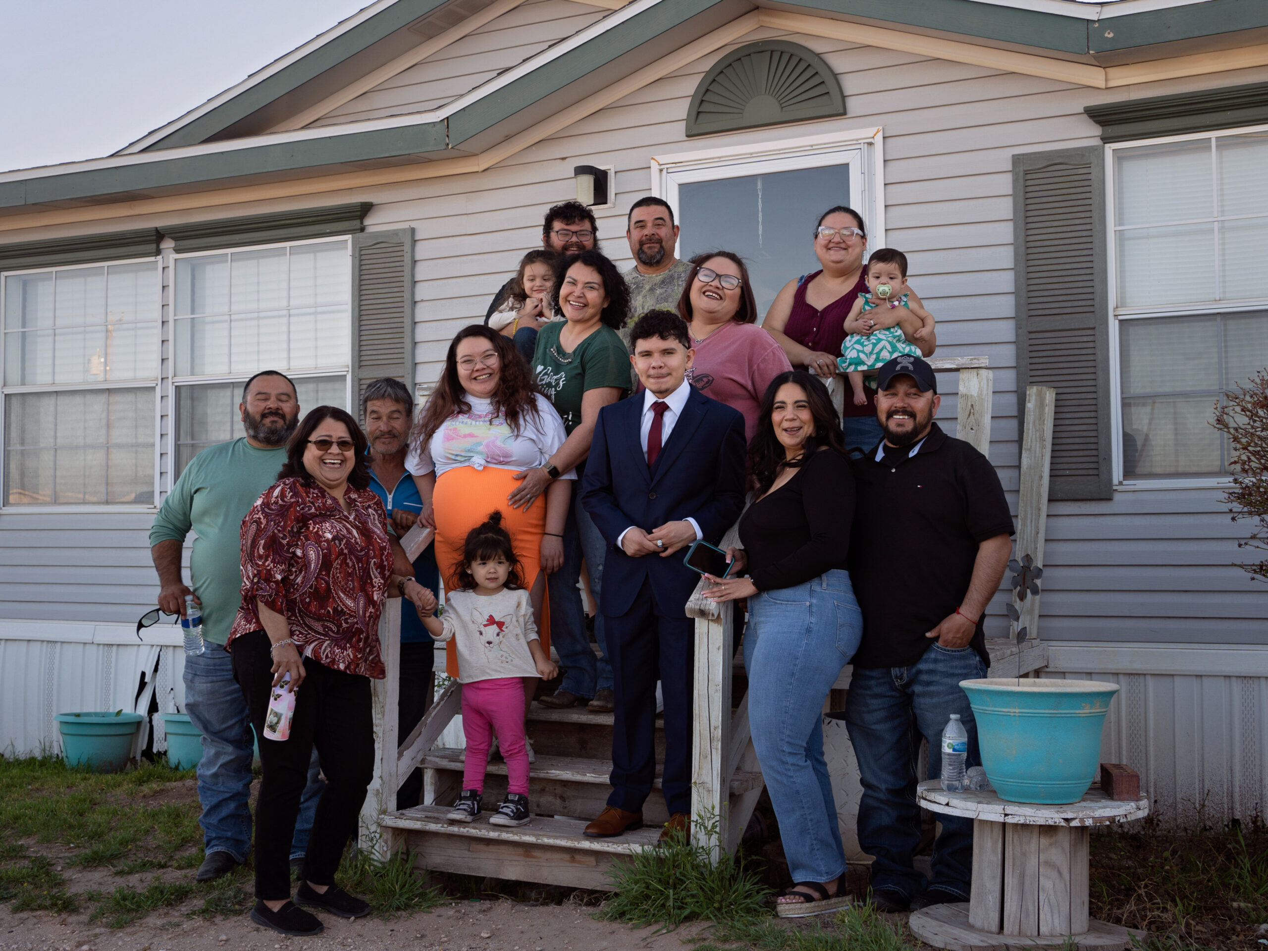 Caitlynn Almance, in the orange skirt, poses for a portrait with family members at her parents' home in Odessa, Texas. "The bond my siblings have with each other – it's just the most beautiful bond ever," says Caitlynn, who is six months pregnant in this photo taken in early March.