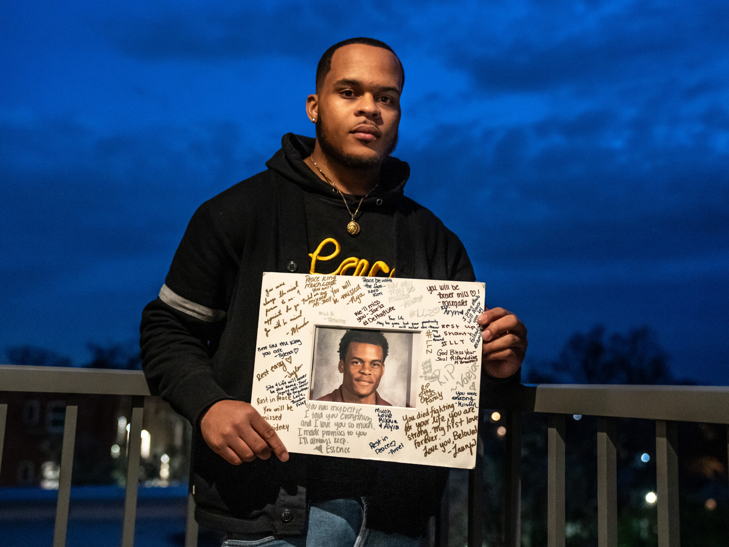 Zion Kelly holds a photo of his late twin brother Zaire B. Kelly.