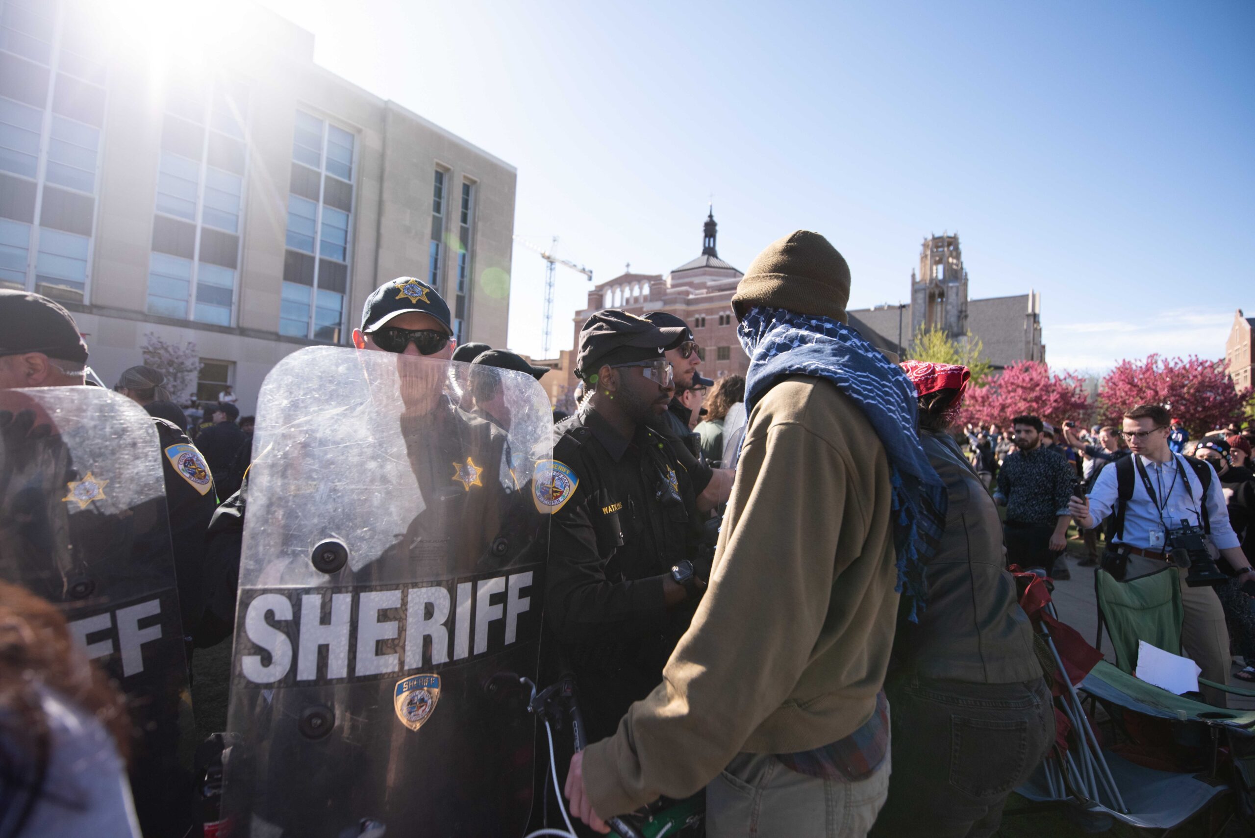 A pro-Palestinian protester confronts police as they begin taking down tents at UW-Madison's encampment.