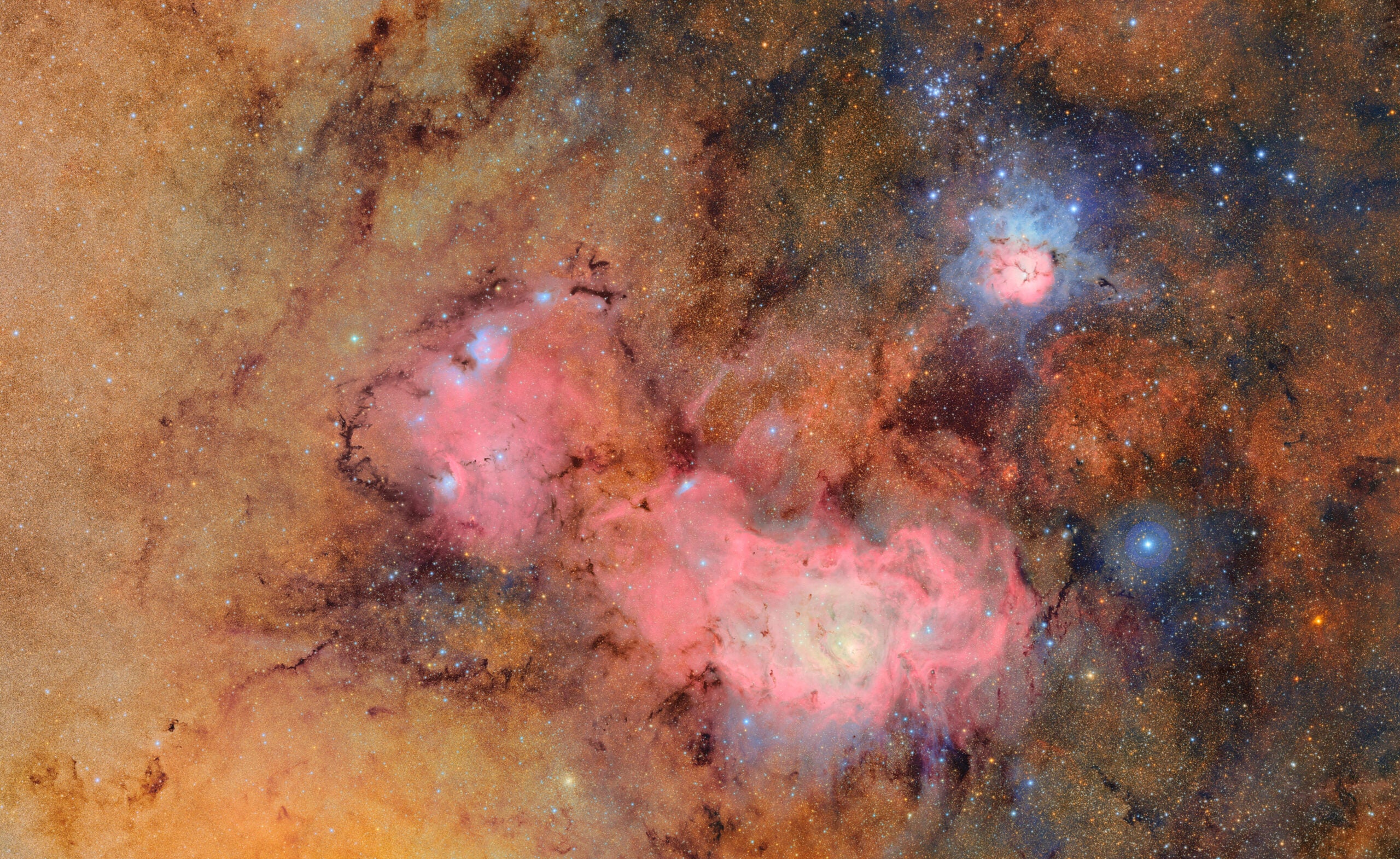 Colorful nebulae and star fields in deep space, featuring vibrant pink, blue, and orange gas clouds with numerous stars scattered throughout the scene.