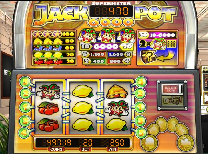 Slot machine displaying reels with lemons, bells, and cherries, a payout chart, coin and bet information, and a jackpot meter showing 6000.