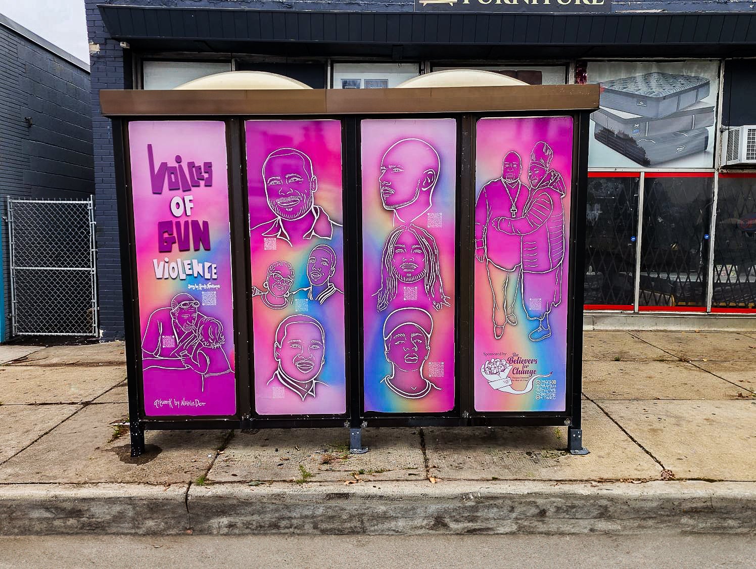A bus shelter features bright, colorful murals with outlined portraits and the text Victims of Gun Violence alongside various illustrated people and memorial symbols.