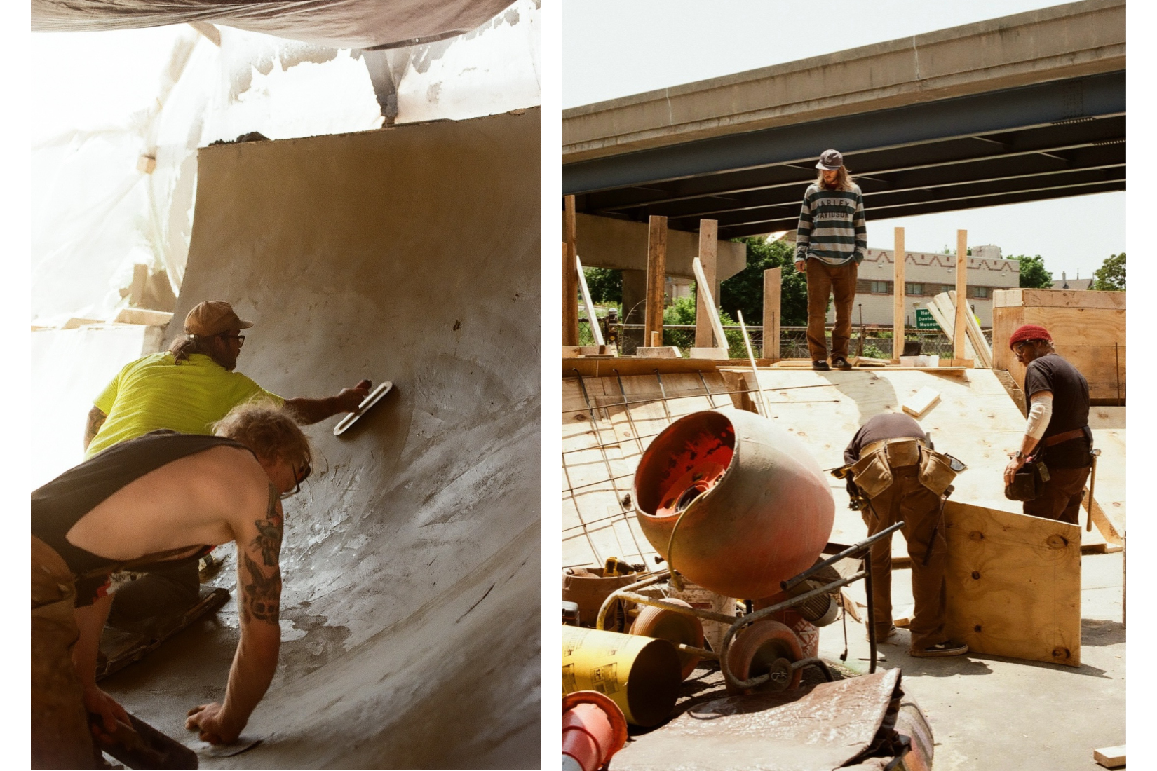 Two construction workers smooth concrete in a skate bowl, while two others stand near a cement mixer at an outdoor construction site under a highway overpass.