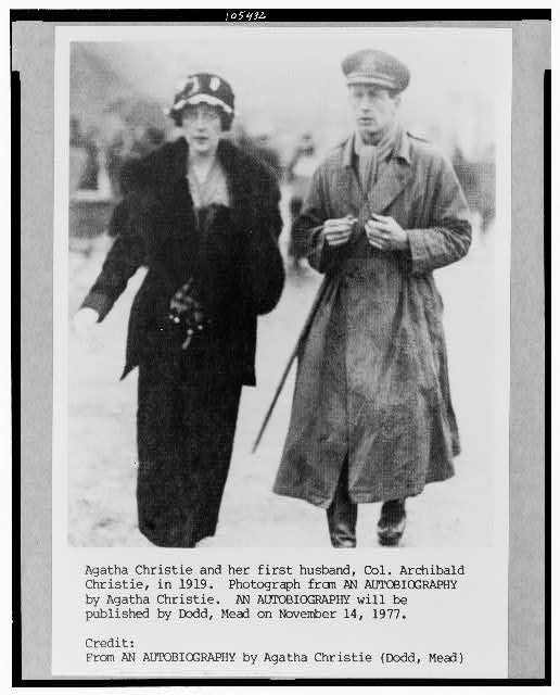 Agatha Christie and her first husband, Col. Archibald Christie, walk together outdoors in 1919, both dressed in early 20th-century attire.