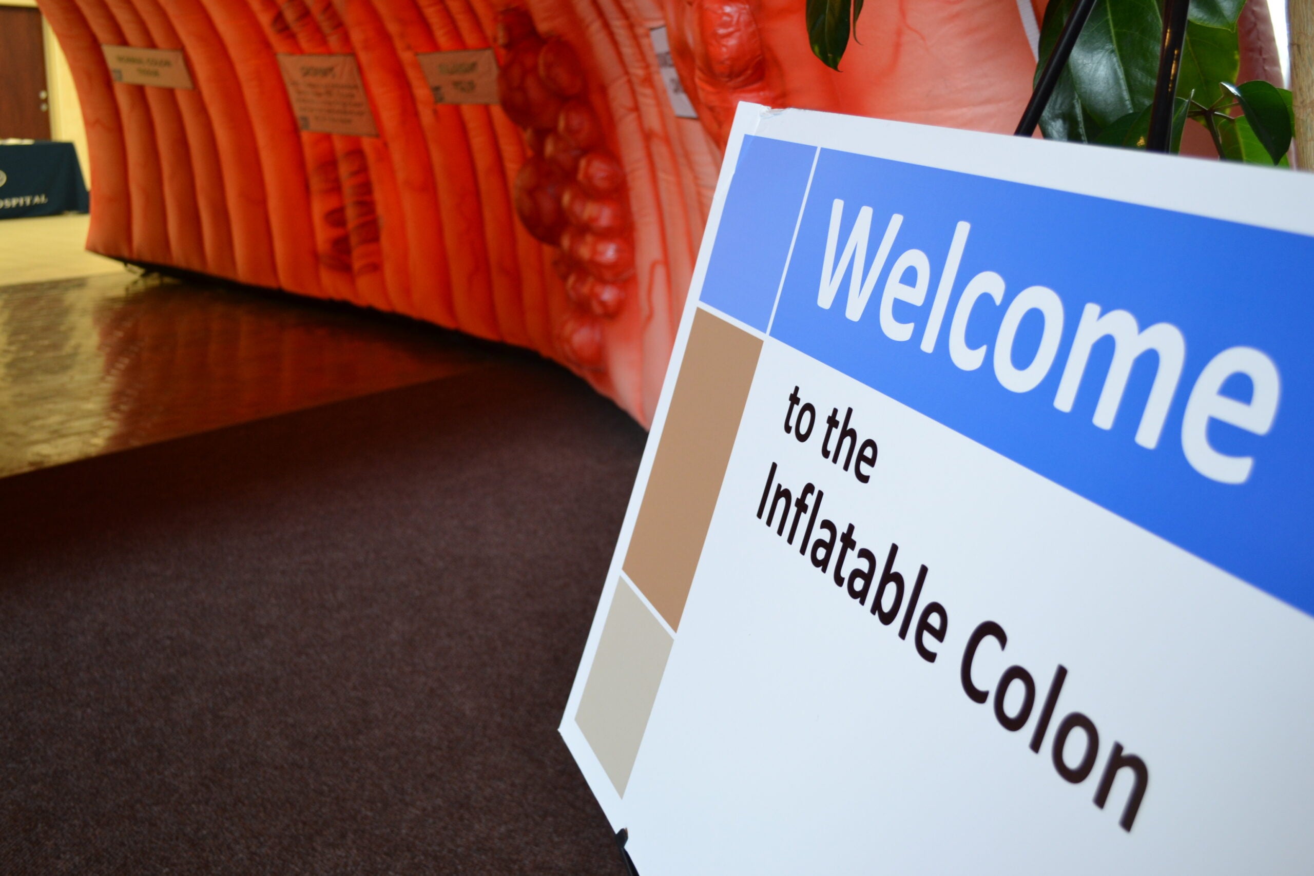 A sign next to an inflatable tunnel.