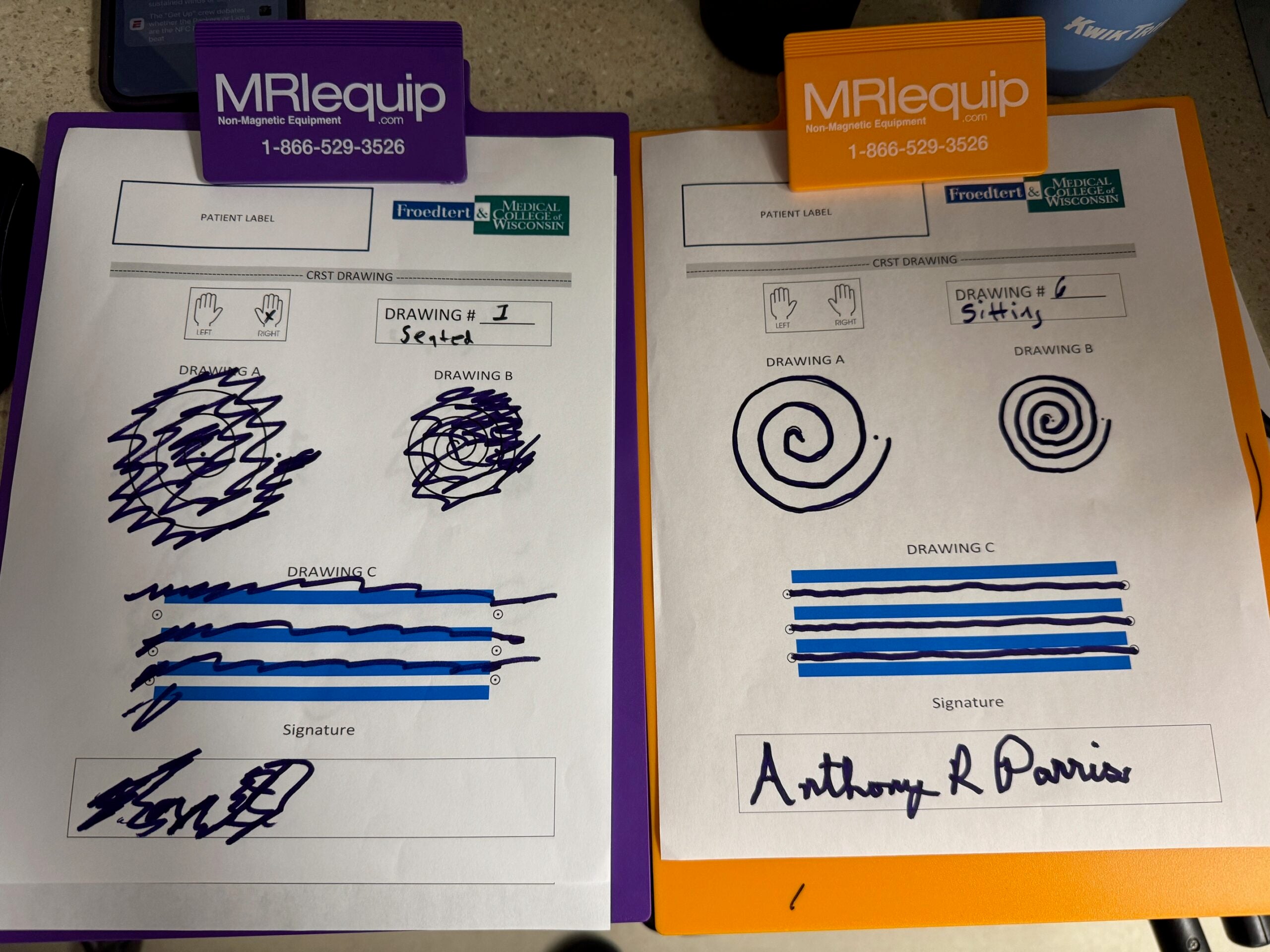Two patient test forms on clipboards display spiral and line drawings, with signatures at the bottom. The forms are labeled “Section I” and “Sixty.”.