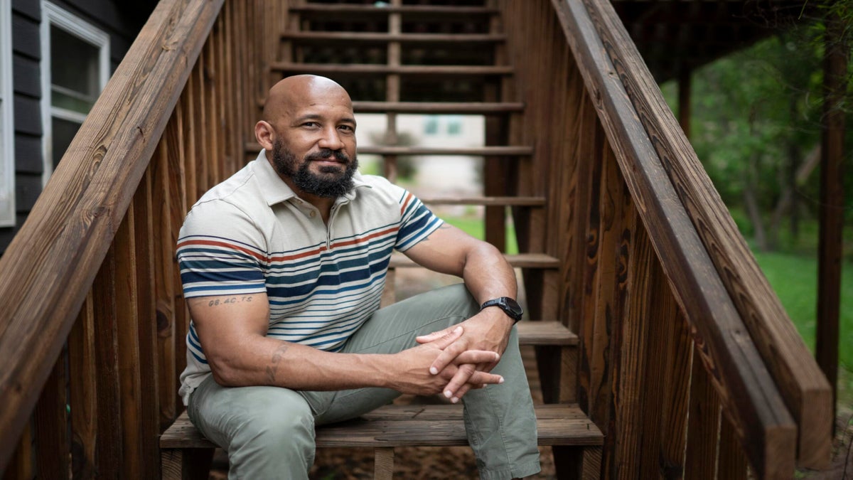 Dave Carlson, of Eau Claire, Wis., poses for a portrait outside his home on May 30. NPR Veterans Correspondent Quil Lawrence and Carlson began corresponding 10 years ago when Carlson, an Iraq vet, was incarcerated. Their conversations follow the evolution of Carlson's life and transformation — from an incarcerated vet struggling with addiction to husband, father and practicing lawyer.