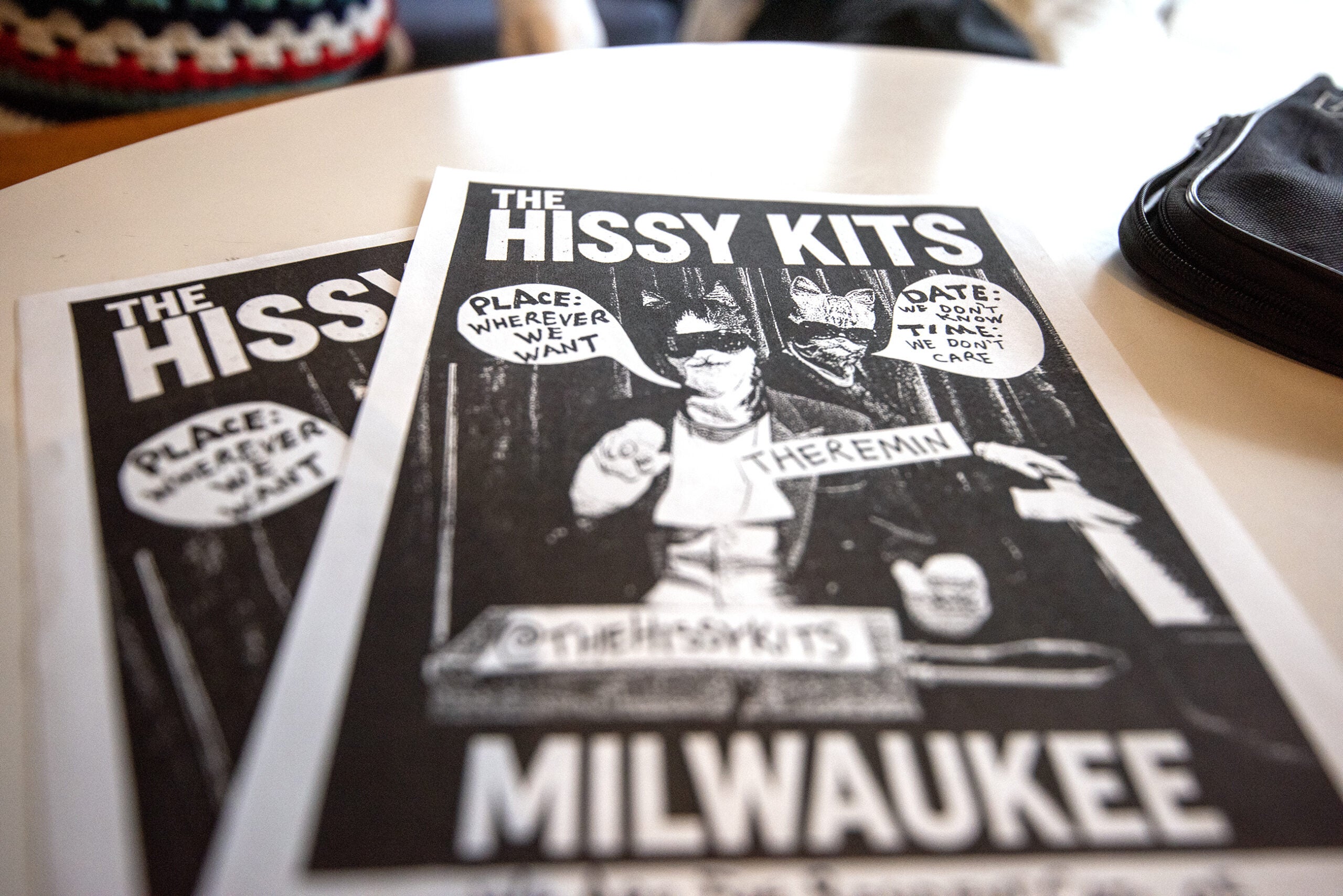 Two printed flyers for The Hissy Kits band in Milwaukee, featuring a black and white photo with speech bubbles and the word THEREMIN.